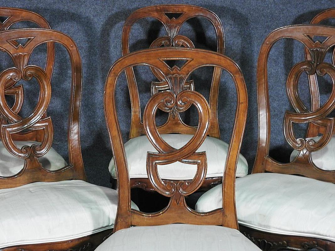 This is a carved set of walnut Italian chairs. The chairs are in good condition and has fairly good upholstery and the frames are in good condition. They each measure 39 3/4