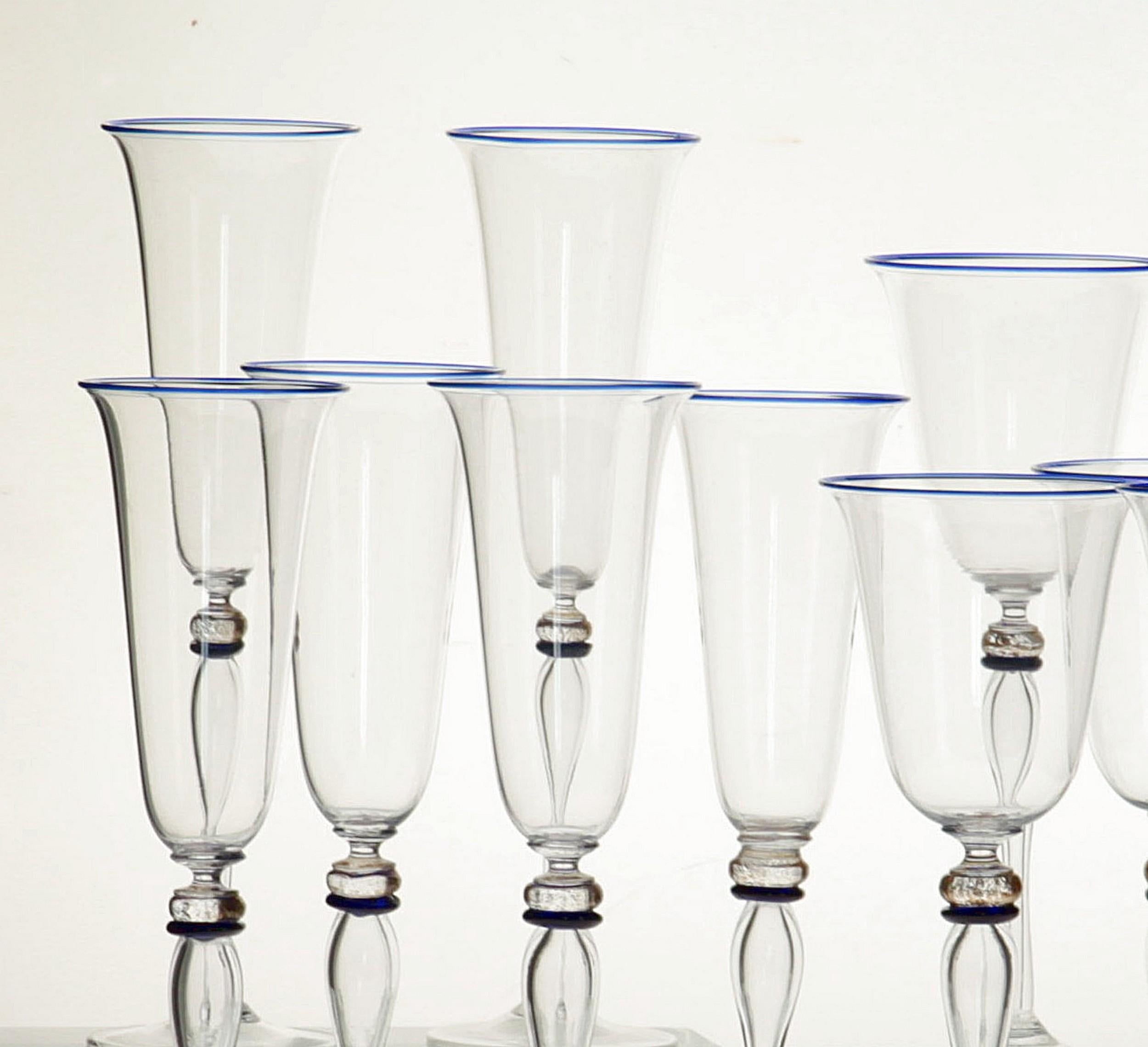 Extraordinary set of 6 stemmed glass from Cenedese.

The stem is blown glass rather than solid glass, resulting in a tall and thin cup. There is a fine cobalt rim at the mouth, a cobalt separator and gold leaf at the neck.

Exquisite manufacturing.