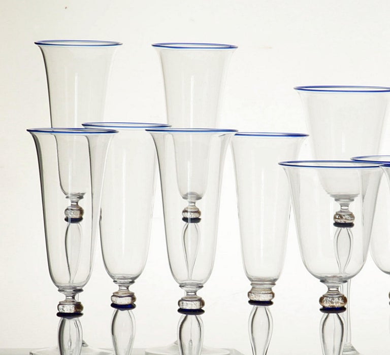Extraordinary set of 6 stemmed glass from Cenedese.

The stem is blown glass rather than solid glass, resulting in a tall and thin cup. There is a fine cobalt rim at the mouth, a cobalt separator and gold leaf at the neck.

Exquisite manufacturing.