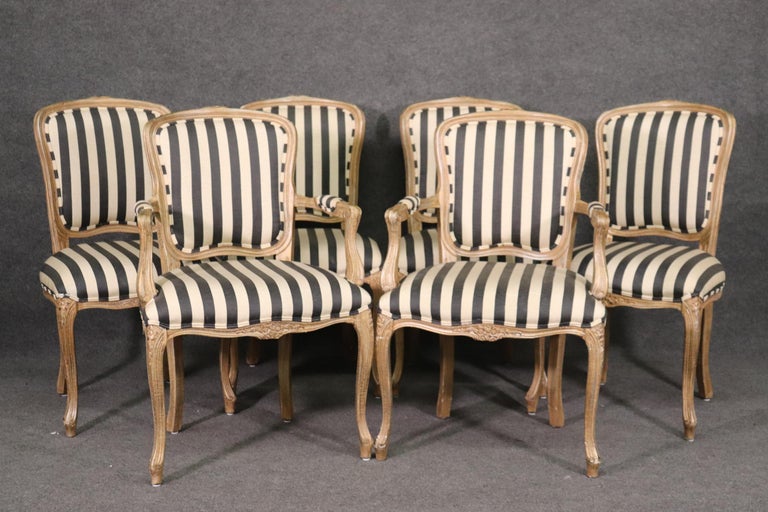 This is a fantastic set of black and white striped moire upholstered painted dining chairs. look at the beautiful antiqued frames and gorgeous fabric. These are neutral and can be used almost anywhere in any design scheme. They measure 39 tall x 25