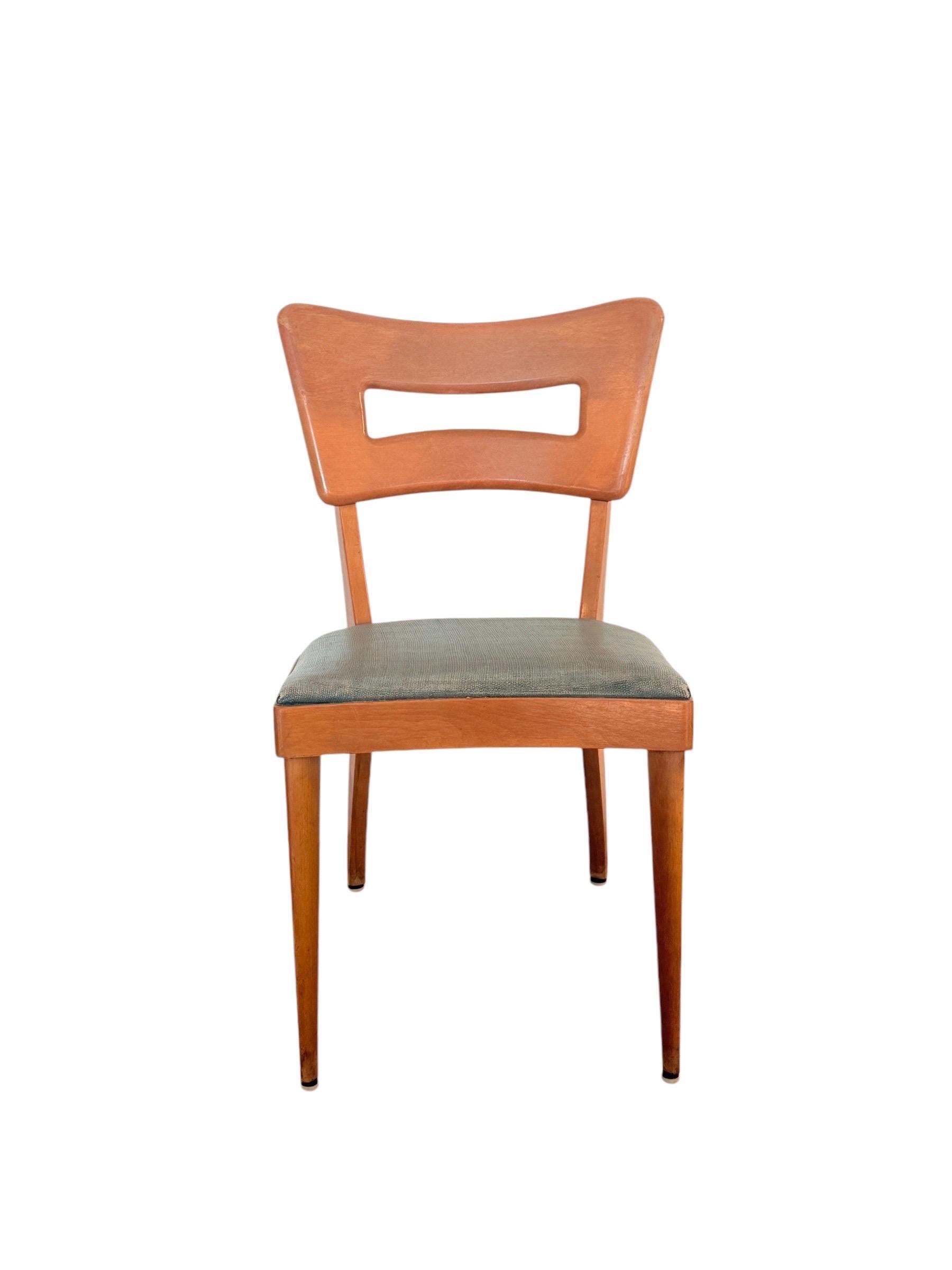 This set of six iconic Dog Bone chairs by Heywood-Wakefield embodies mid-century design at its finest. Renowned for their sculptural elegance, these chairs feature a distinctive cutout backrest that adds visual interest while maintaining clean,