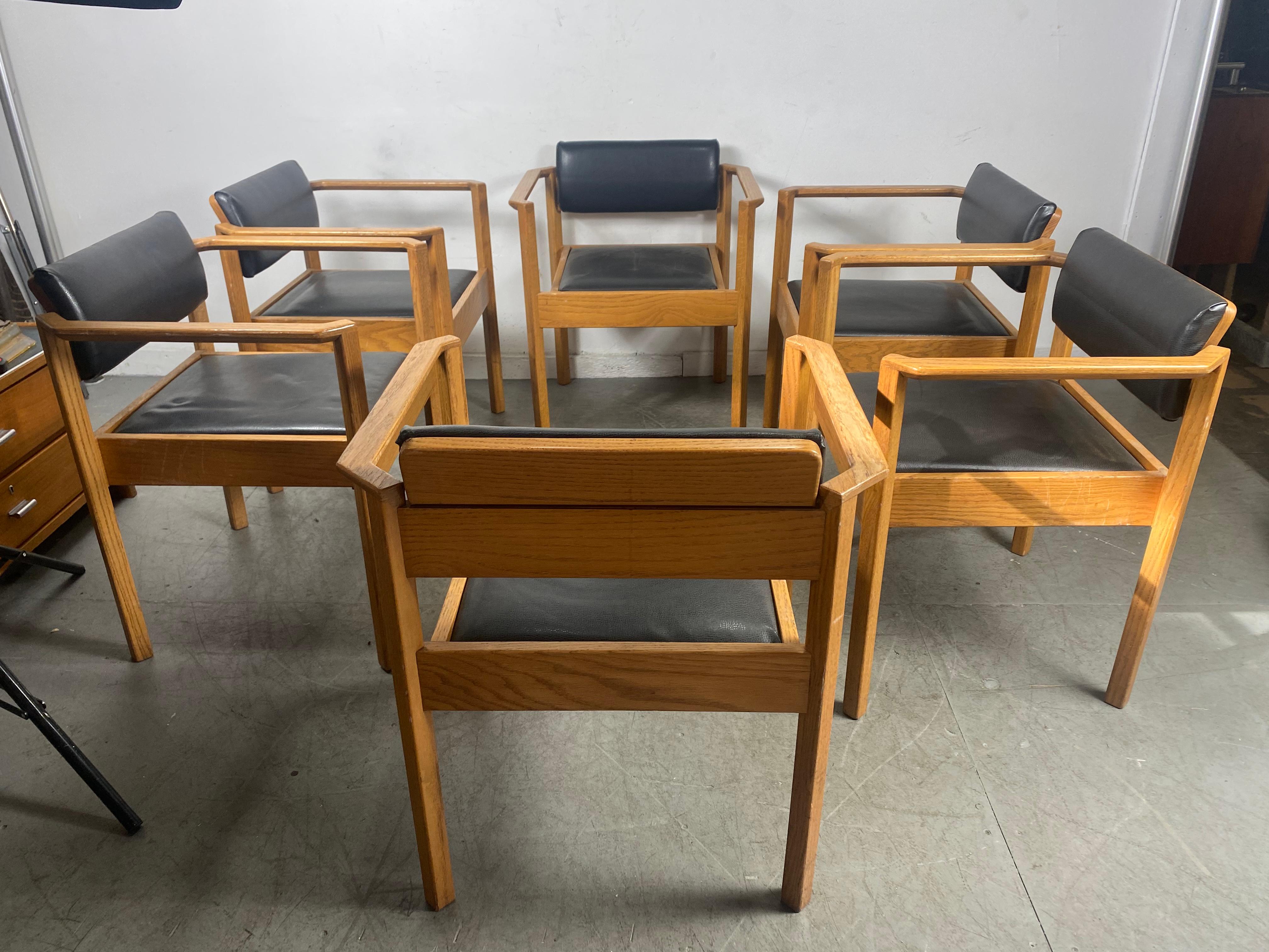 Unusual set of 6 architectural stacking arm chairs / dining / conference, amazing design, manner of frank Lloyd Wright. Superior quality and construction, oak frames retains original color, finish, patina. Seats reupholstered in leather, solid