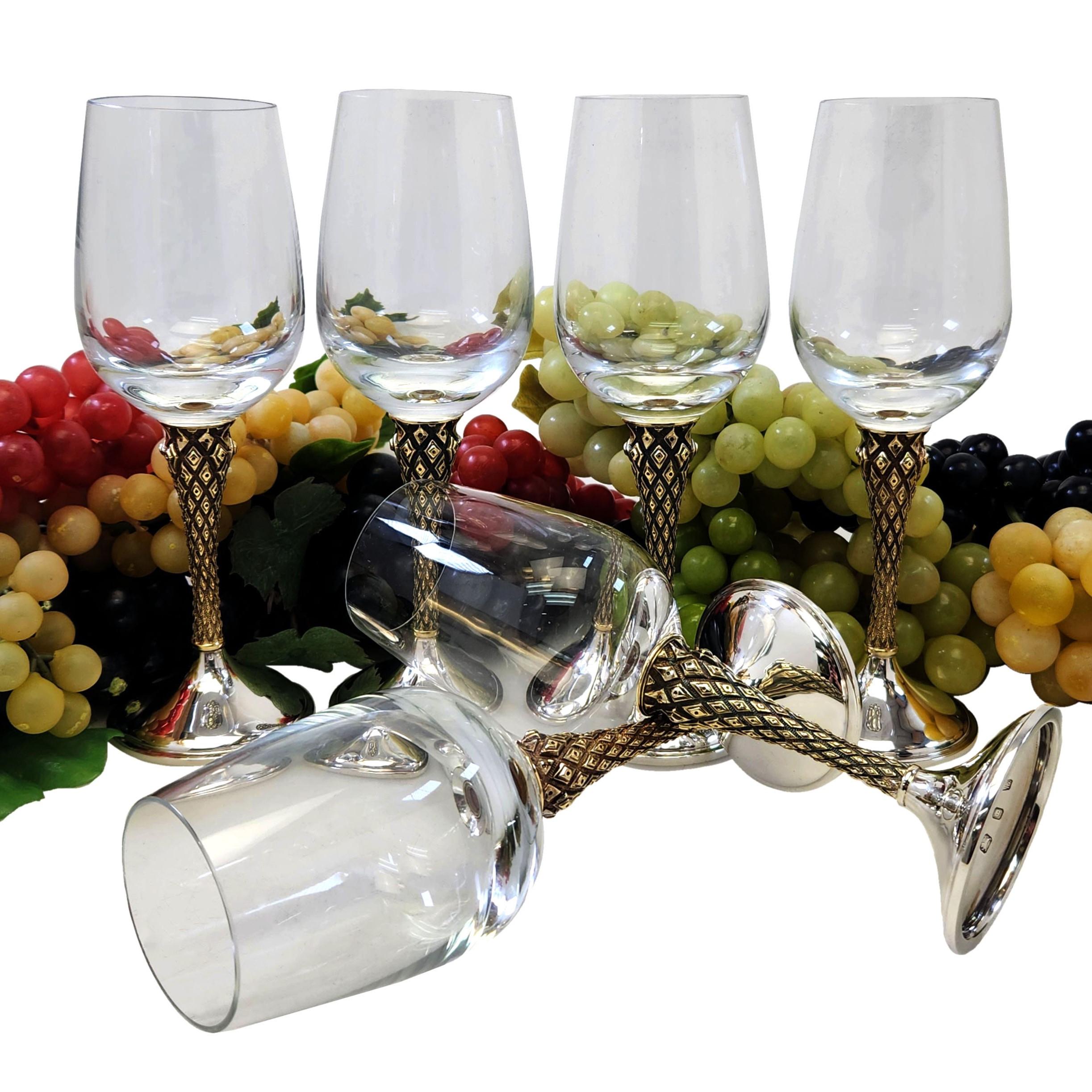 A beautiful Set of 6 Silver & Glass Wine Glassed in a dark blue fitted case.  Each Wine Glass has a clear Glass Bowl fitted into a patterned Silver Gilt Stems with plain polished Silver Bases. Each Glass Bowl unscrews from the stem to allow for easy