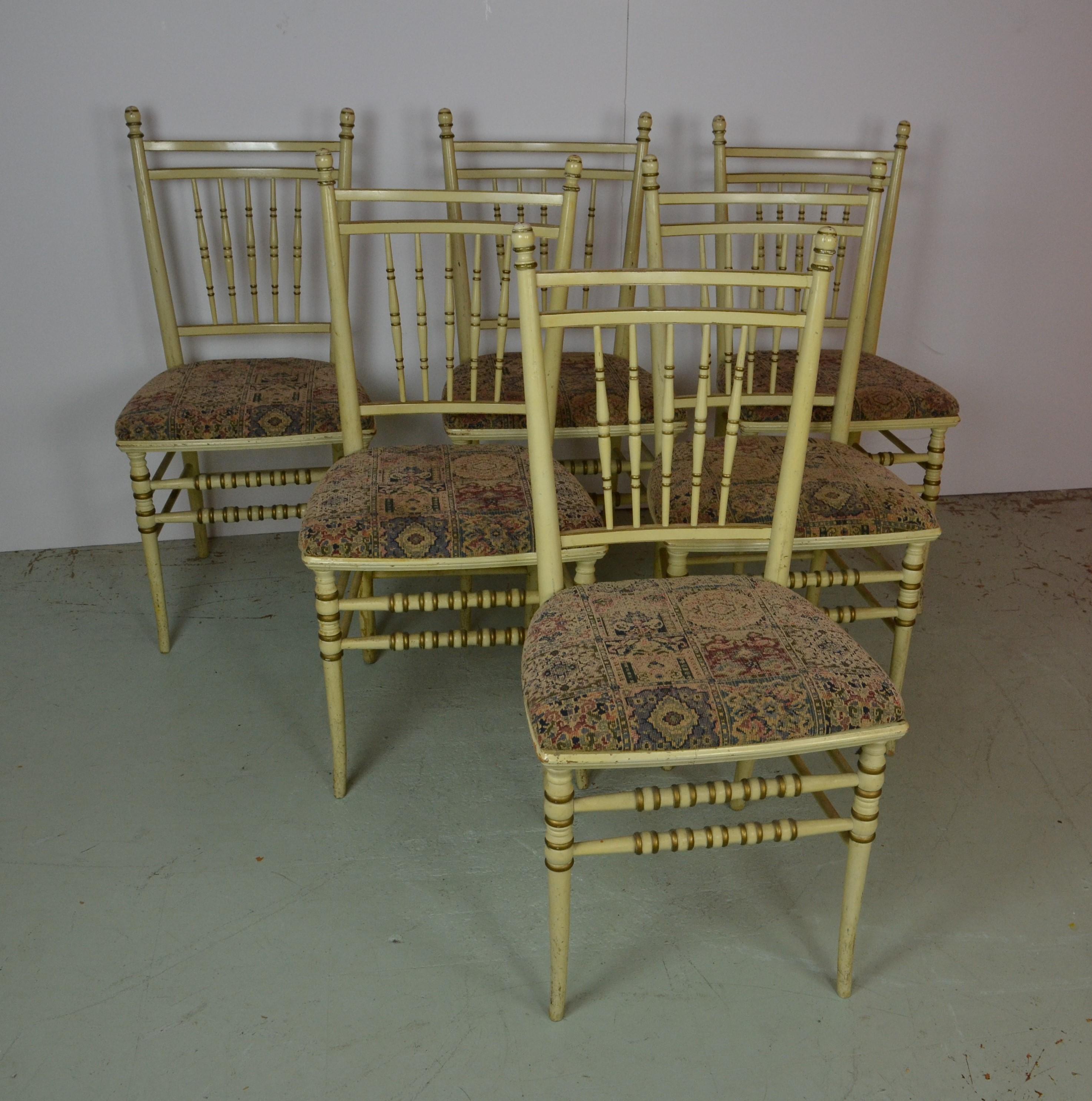 A set of 6 petite Spindle-back chairs finished in their original cream paint finish. Highlights in gold. Upholstered in a 
