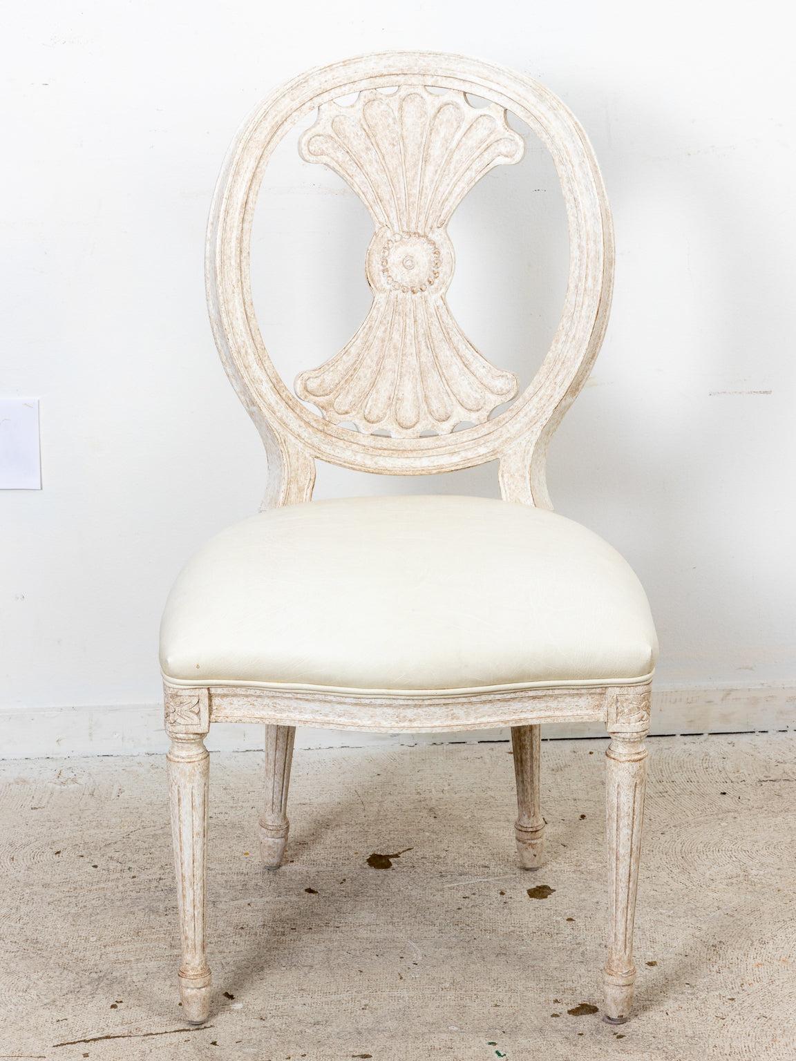 Set of 6 Swedish style dining chairs with distressed white wash finish and tight vegan leather upholstered seats. Please note of wear consistent with age.