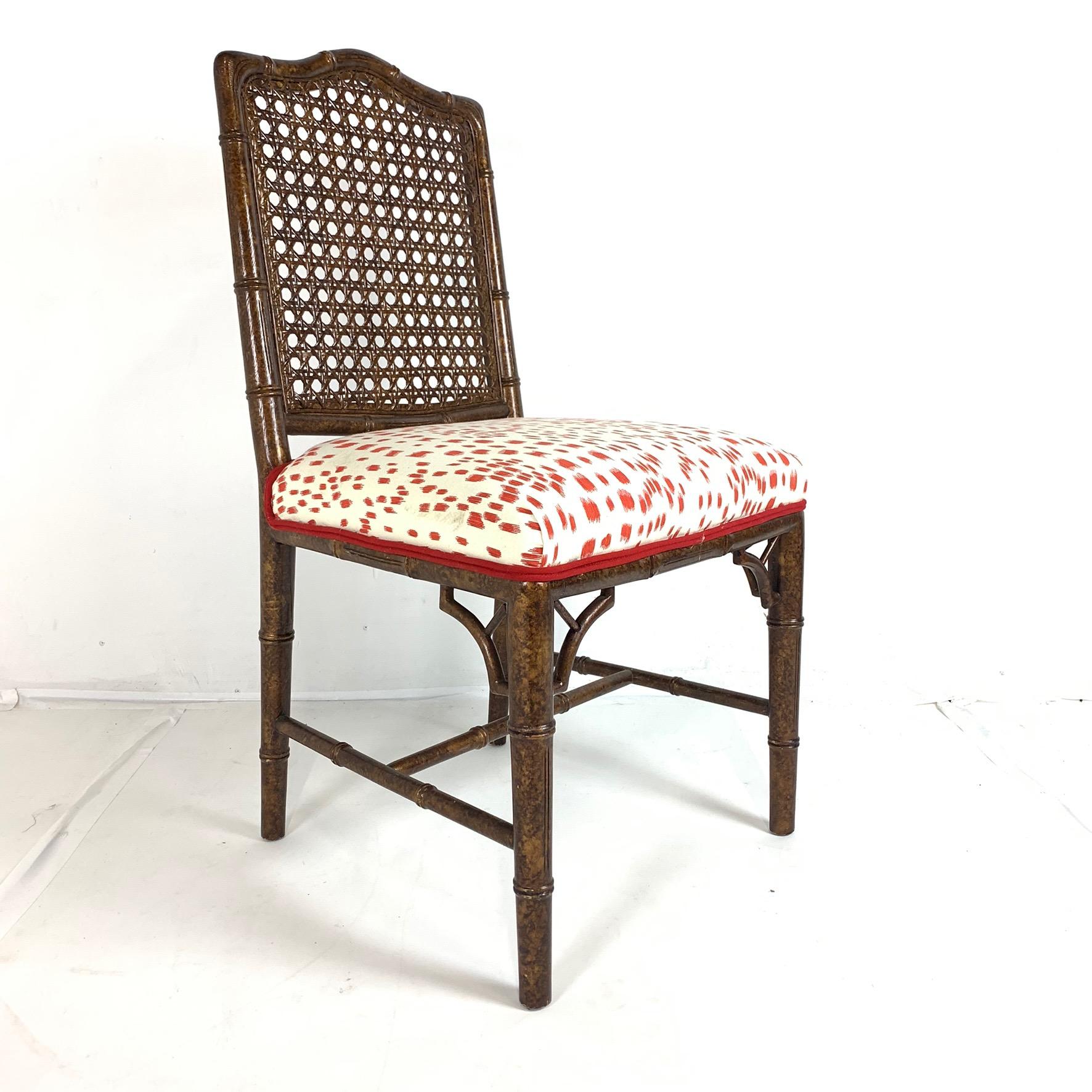 Set of 6 stunning faux bamboo wood chairs with amazing upholstery. Frames are carved hardwood with a lovely painted faux bois finish. Back of chairs is a lovely cane and seats have an incredible upholstery. This is a fabulously unique and usable