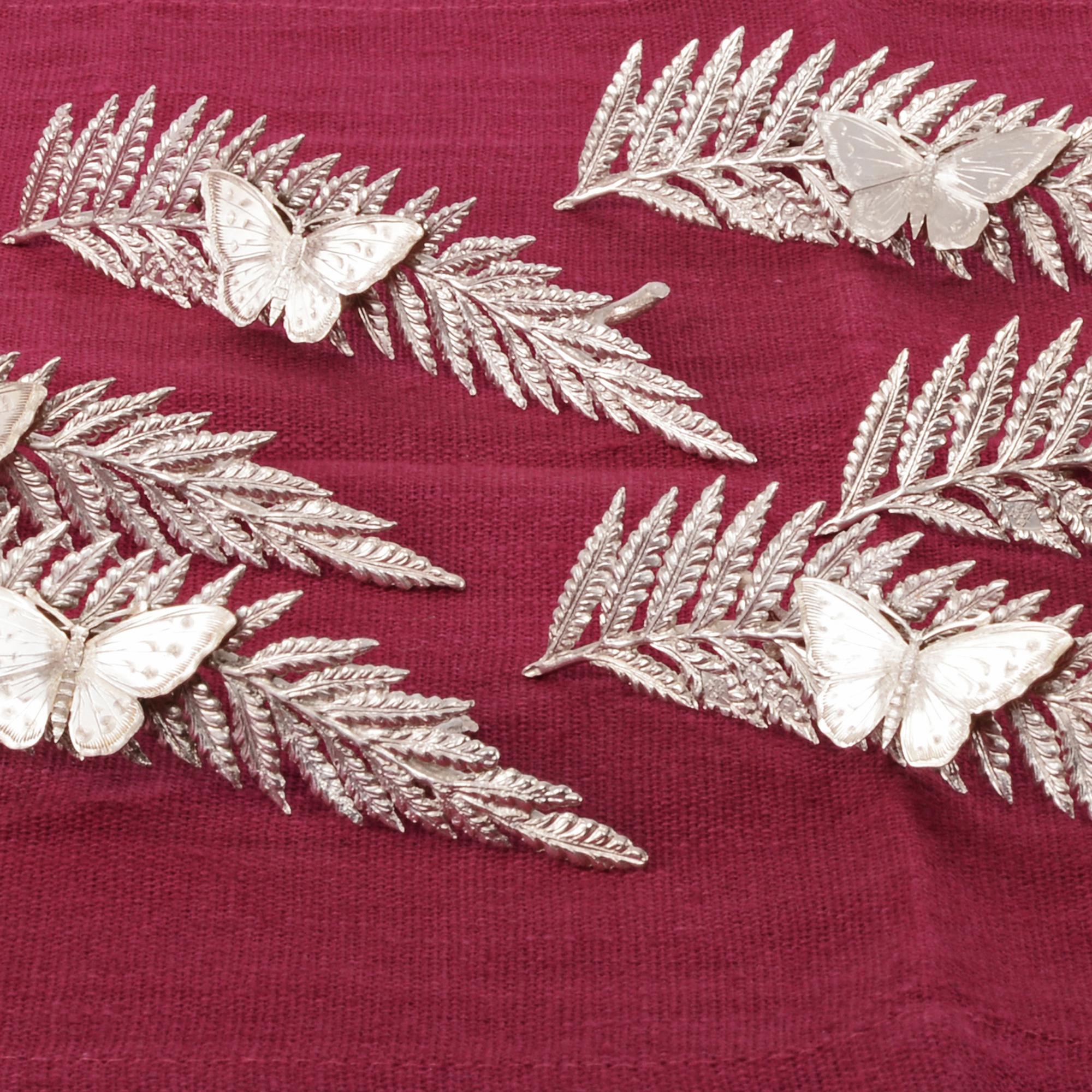 Highly unusual set of antique sterling silver menu holders or place card holders, each beautifully modelled as a fern leaf with a butterfly resting on the leaf. The butterflies act as sprung clips to hold the menu or card in place and are cleverly