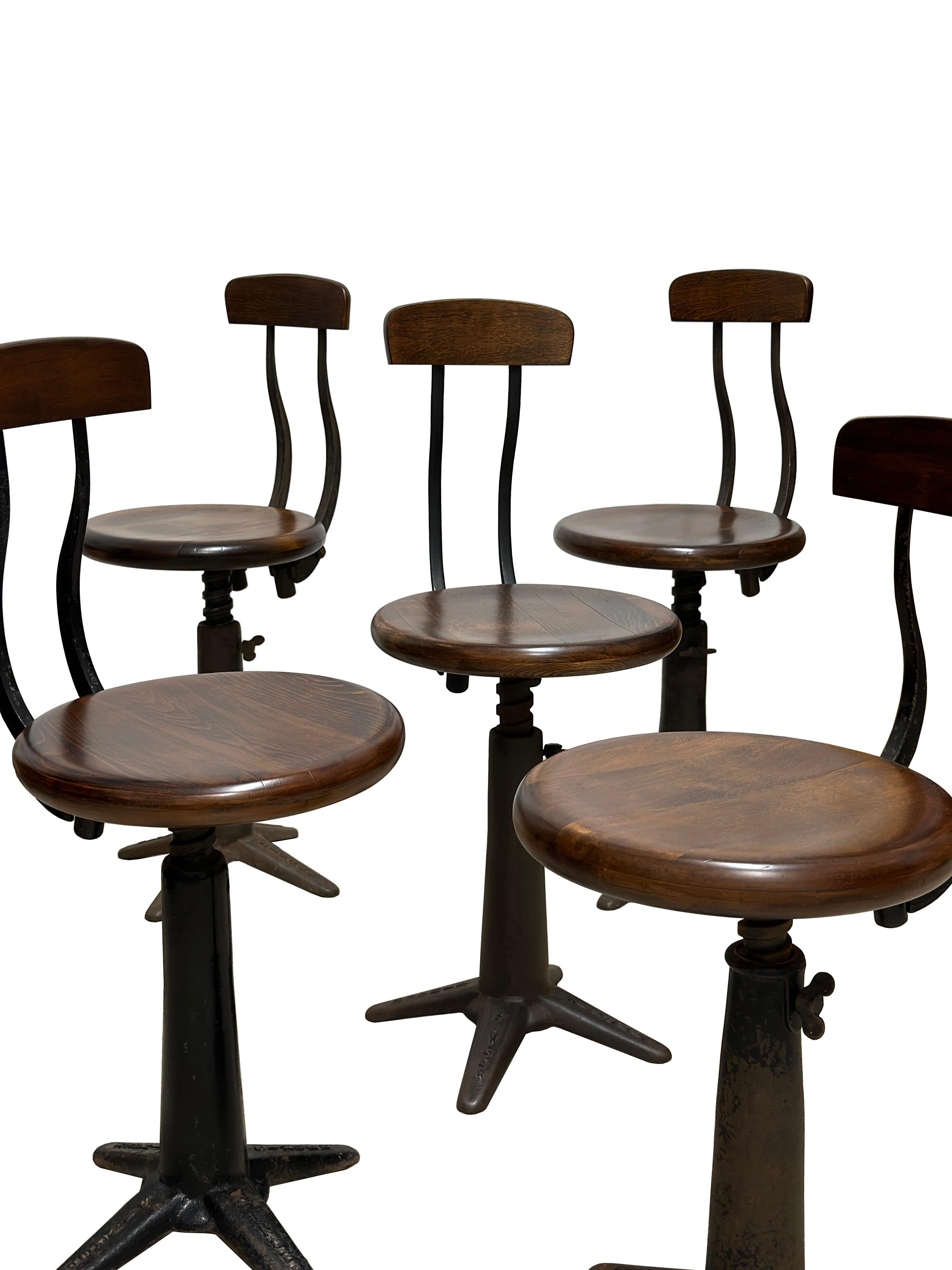 - A magnificent set of six iconic and rare Singer sewing spring back factory chairs, English circa 1920.
- Cast iron construction, sprung backrests, height adjustable chunky seats, all feet marked Singer, they have all been recently French polished