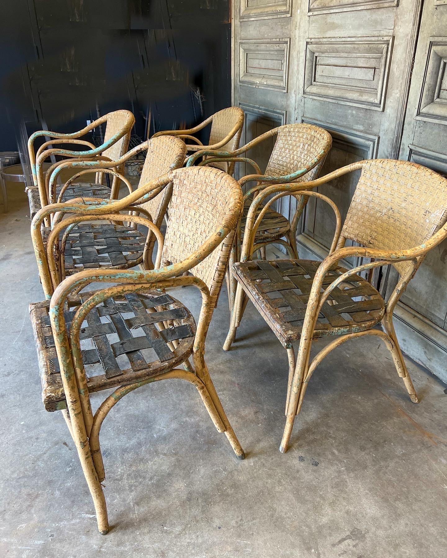 This vintage Spanish set of 6 chairs were recently discovered in the Catalonia region of Northern Spain and are crafted from bamboo with a lovely patina of distressed paint and woven cane back. The seat itself is crafted of rubber strips making it