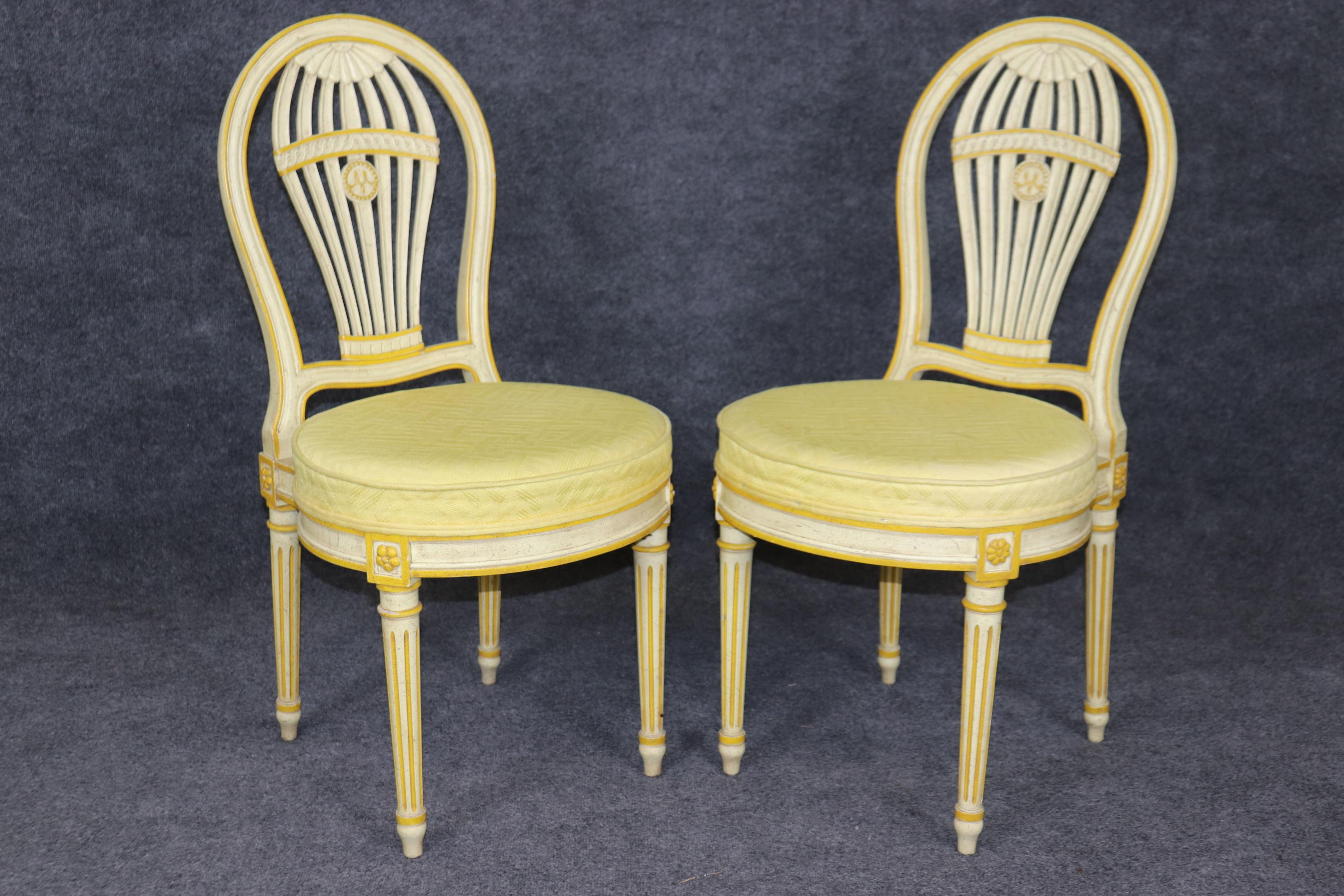 This is a gorgeous set of dining chairs that accurately reproduce the iconic Maison Jansen Balloon Back dining chair. These are made by John Widdicomb, one of America's finest furniture manufacturers. The finish is an antique distressed creme or
