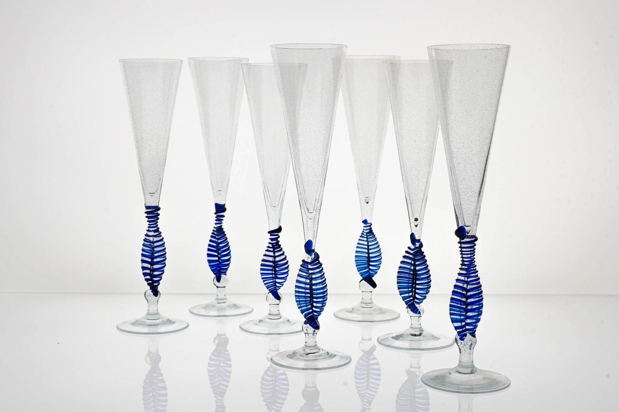 This unique set of flutes from Cenedese is a rare and exclusive find. Made in Murano in the 1950s by one of the best glassmakers of the time, these flutes are completely handmade and feature a delicate Cobalt blue spiral bead on the twisted double
