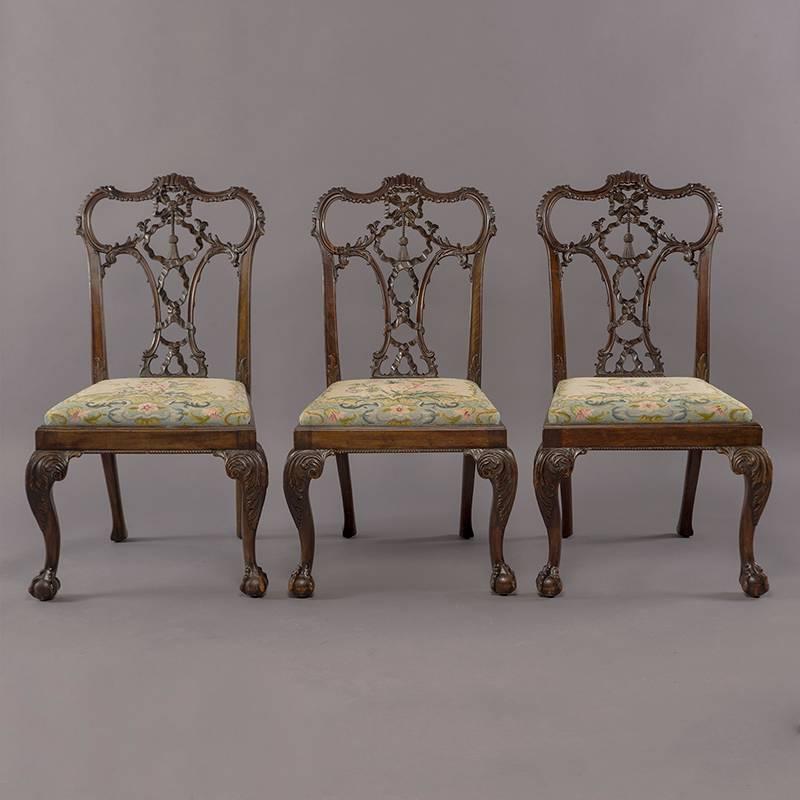 Set of eight circa 1860s finely carved English mahogany Chinese Chippendale chairs. Two armchairs and six side chairs. Acquired from estate of John F. Gordon, former CEO and President of General Motors. Chairs have ornately carved tassel backs, ball