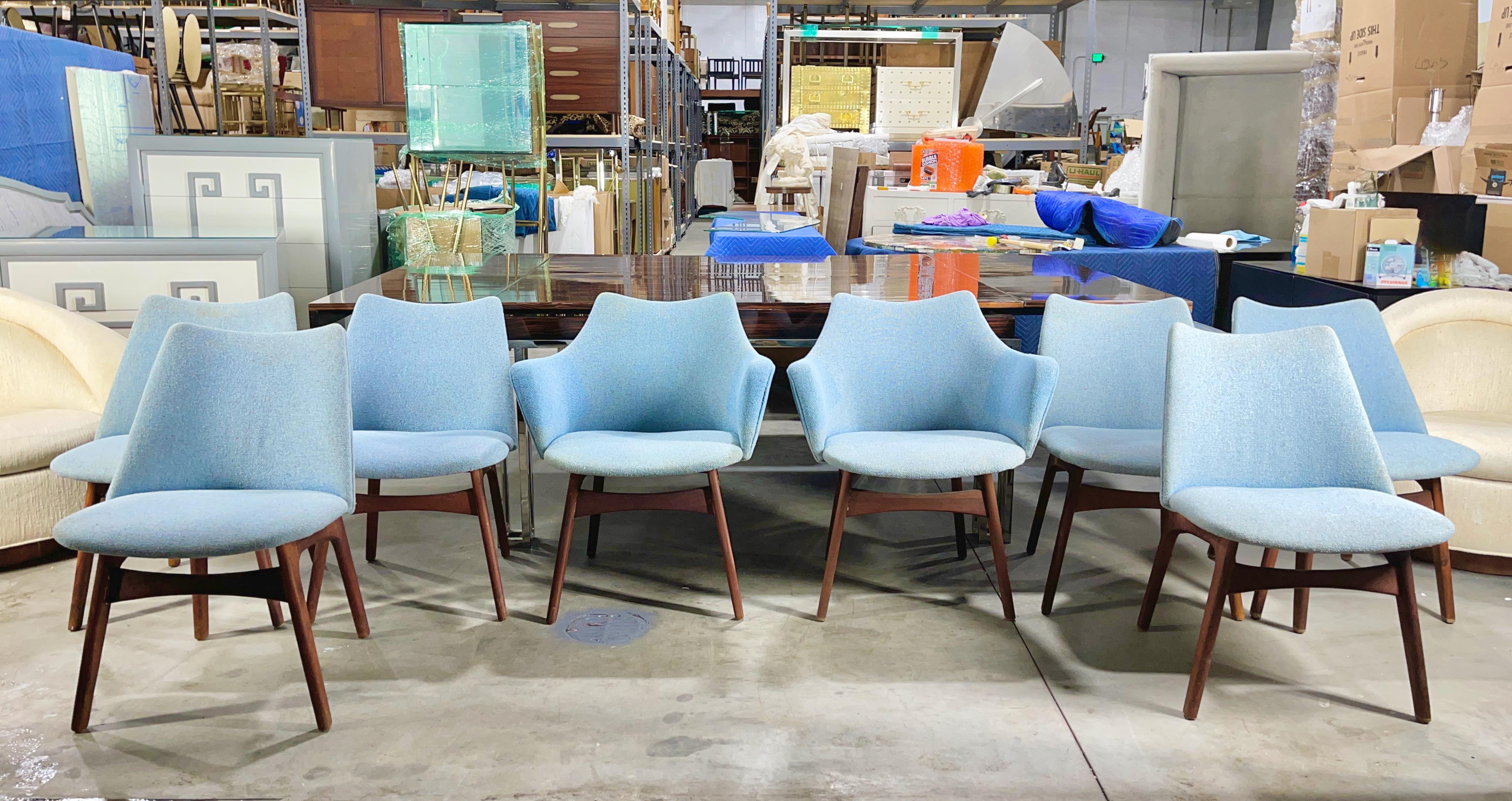Set of eight dining chairs designed by Adrian Pearsall for Craft Associates in 1969, polyfoam over moulded plywood seat and back on sculptural walnut frames, presented in their original blue (clean but faded) nubby wool upholstery.
Two captains