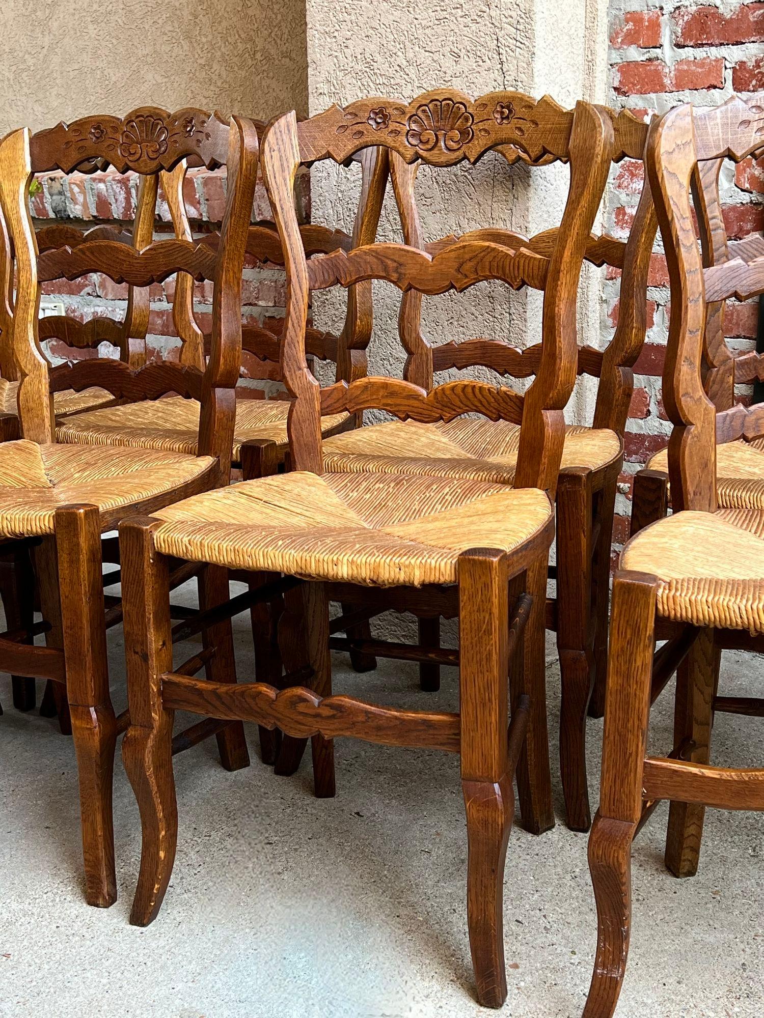 Set 8 Antique French Country Dining Chairs Carved Oak Rush Seat Ladder Back In Good Condition For Sale In Shreveport, LA