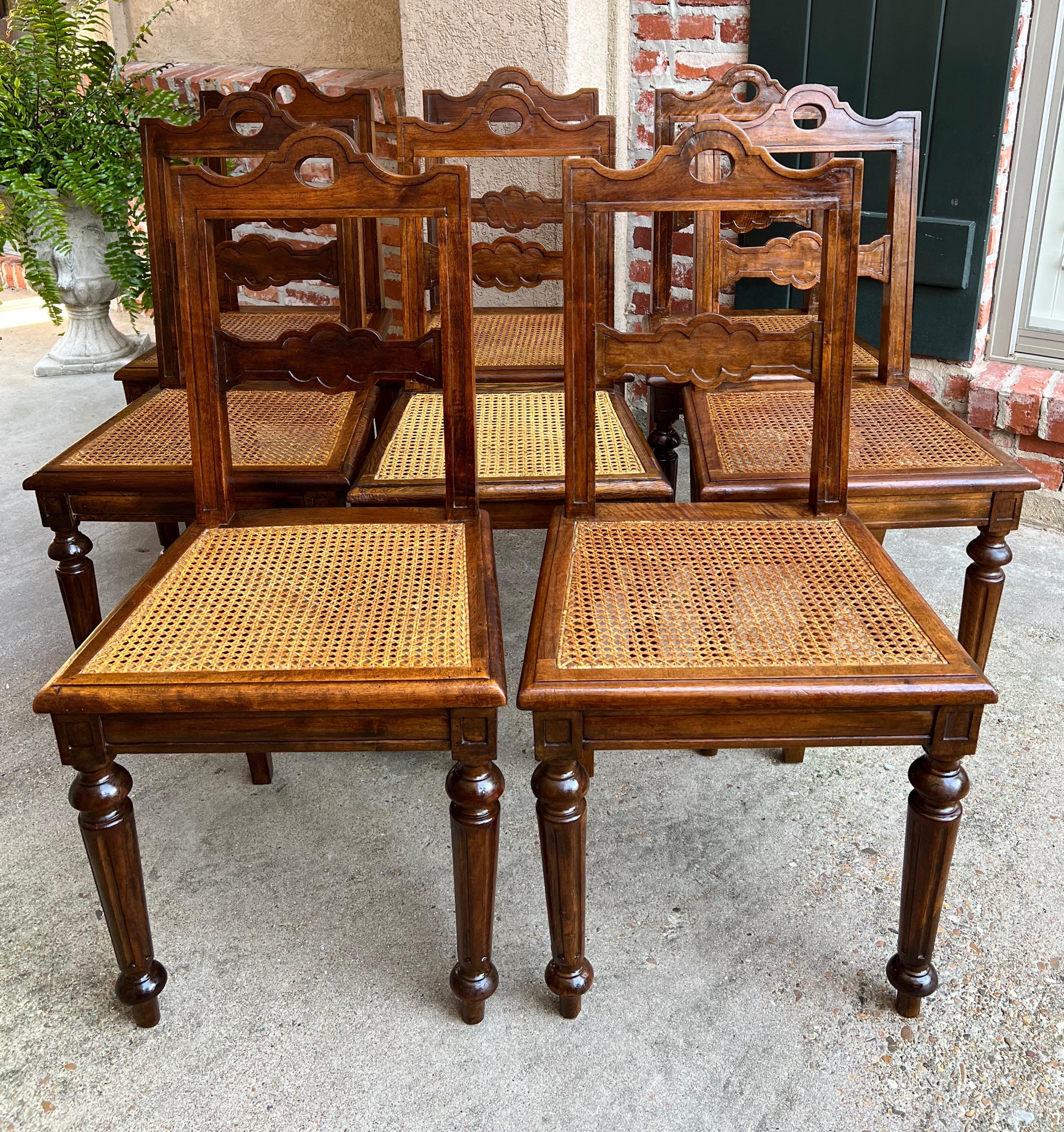 Set 8 Antique French Provincial carved oak ladder back dining kitchen chair cane seat.

Direct from France, a lovely set of 8 antique French chairs with classic French style. Shaped panel ladder backs with arched upper crowns and shaped horizontal