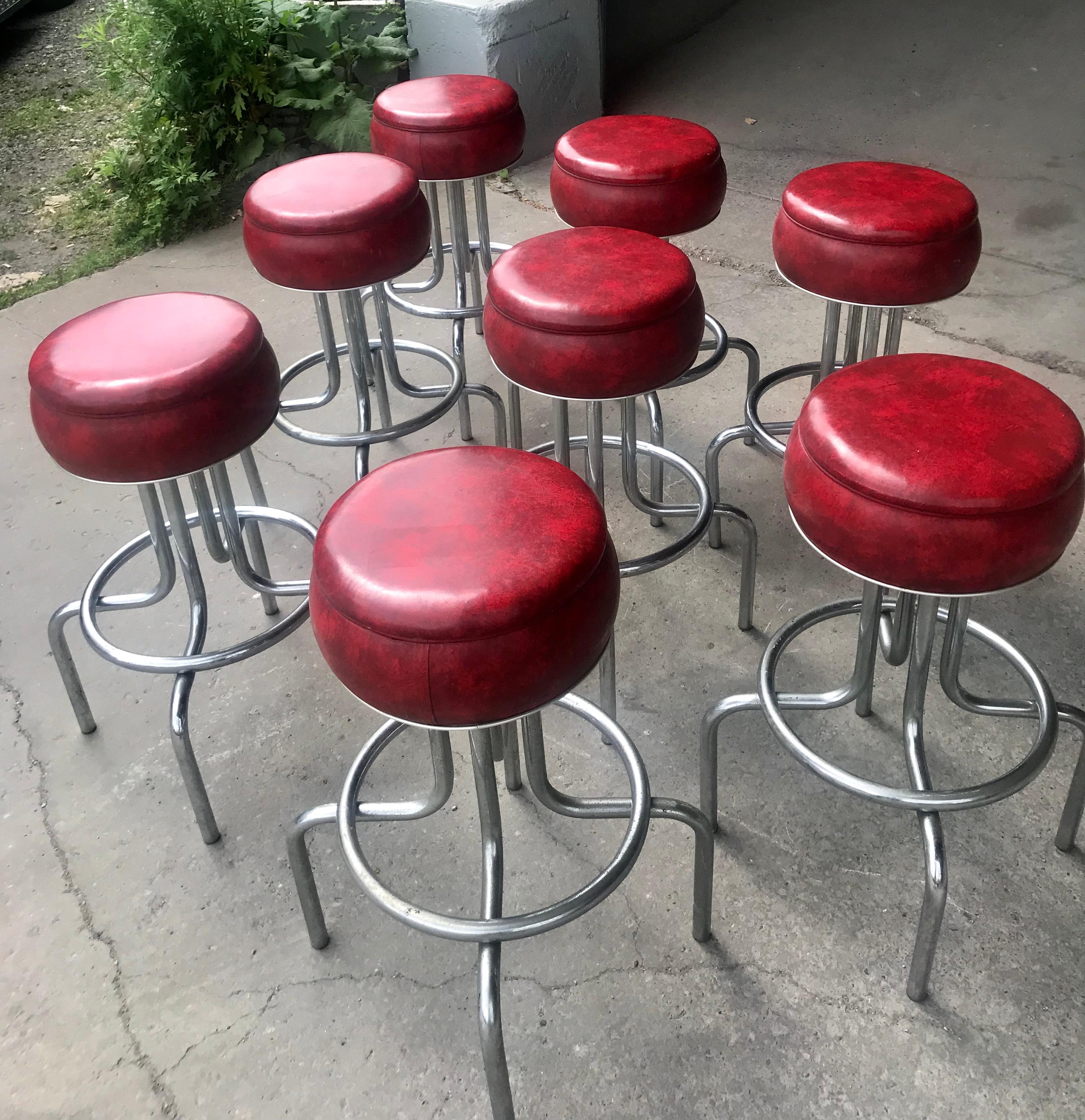 Set 8 Art Deco stylized red and chrome bar / counter stools attributed to Wolfgang Hoffmann,, Stunning design, swivel tops. Retain original red naugahyde fabric.