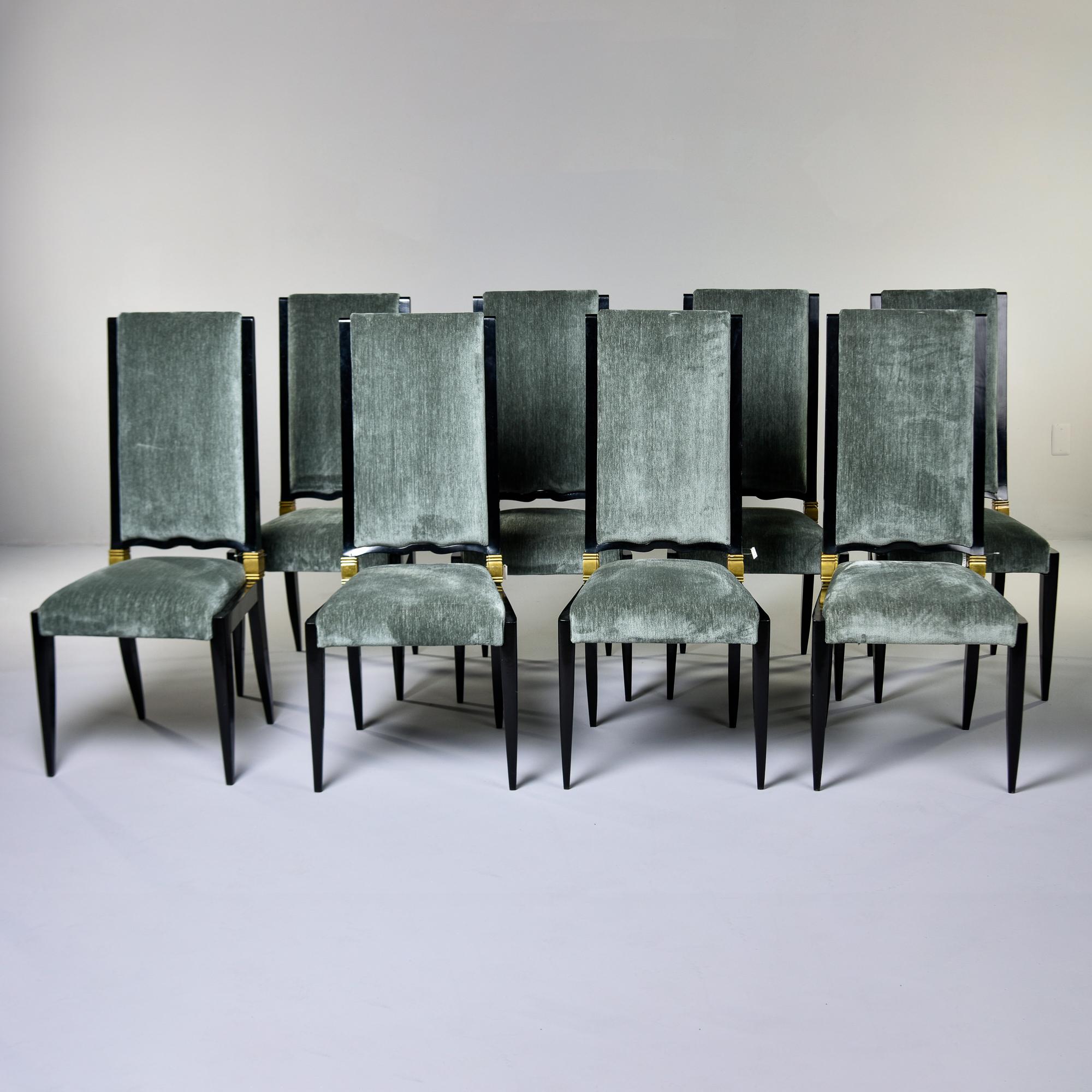 Found in France, this set of eight dining chairs attributed to Jules Leleu date from the late 1930s / early 1940s. This set of chairs feature solid sycamore frames with newly ebonized finish and decorative brass mounts that wrap around the back