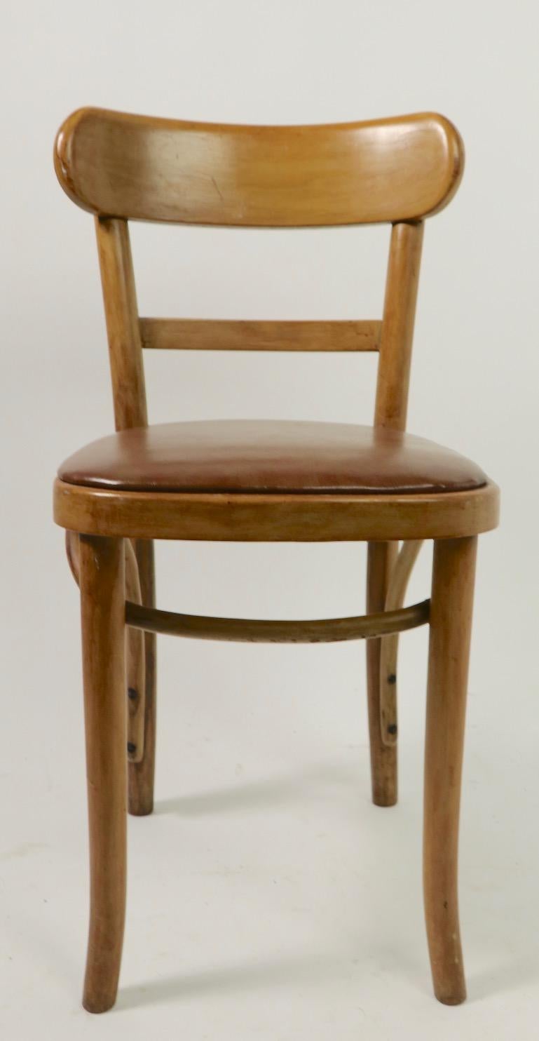 Set of 8 matching bentwood cafe, bistro chairs made by Kohn Mundus. All are structurally sound and sturdy, some have minor flaws to the upholstered seat pad (see pictures). Priced and offered as a group.