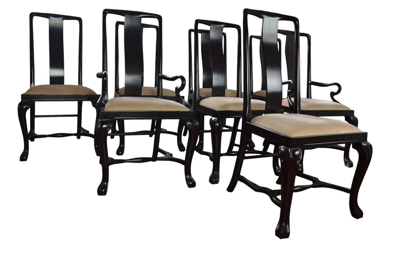 A set of 8 lacquer finish dining chairs in a transitional style from Queen Ann to Chippendale. The seats are covered in original fabric. Measures: Armchairs 41