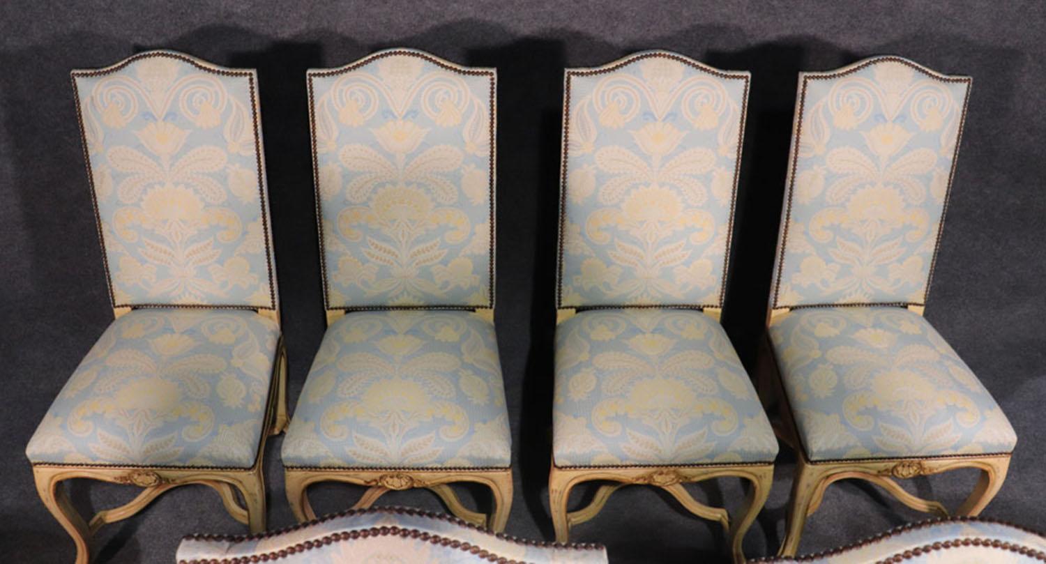 This is a stunning set of Maison Jansen dining chairs in contrastic robin's egg blue damask upholstery with nailhead trim and beautifully painted and gilded frames. Notice every detail of these chairs including the upholstery of the back which is