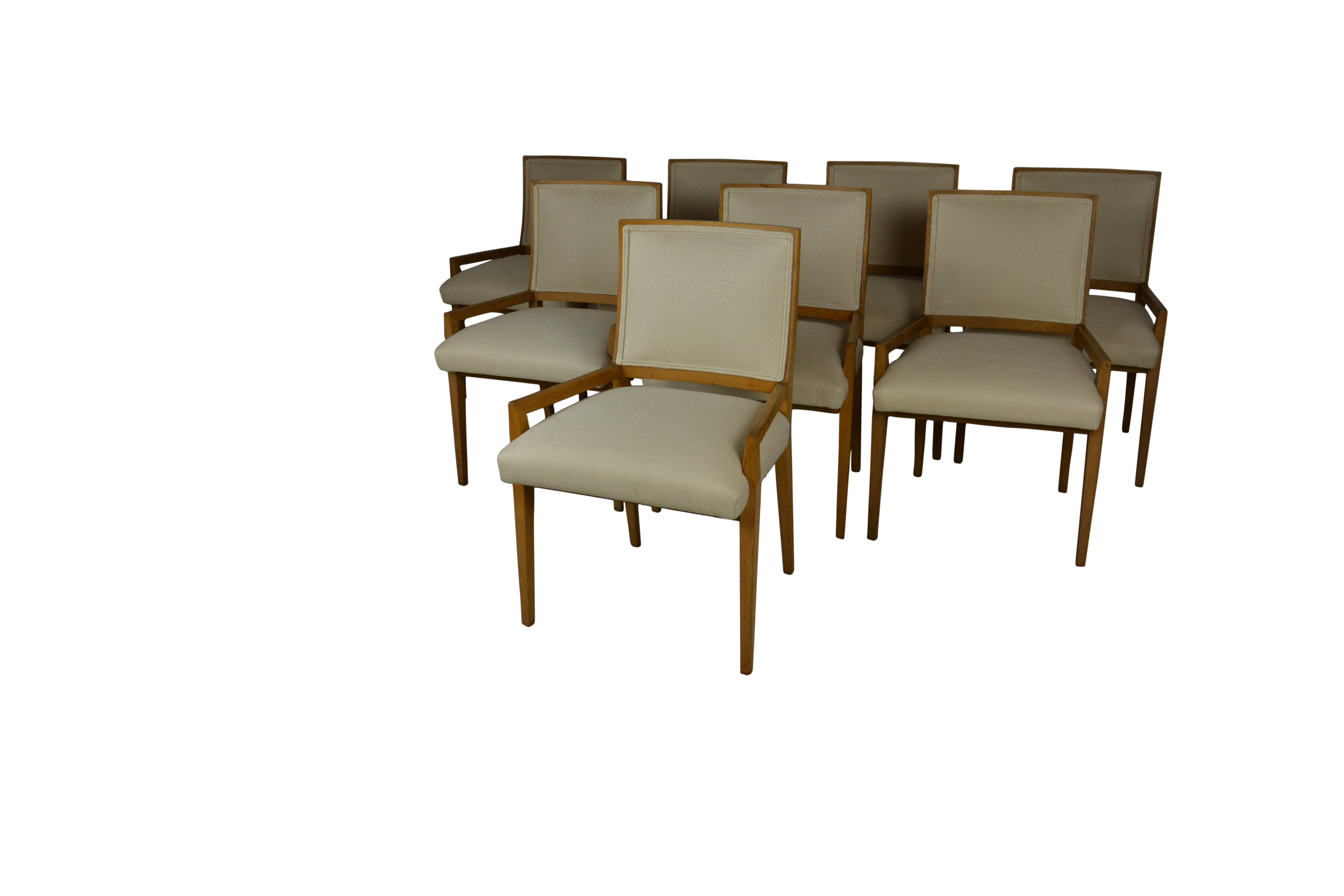 A set of 8 midcentury dining chairs in maple-wood. All new neutral color upholstery. Low arms on all.