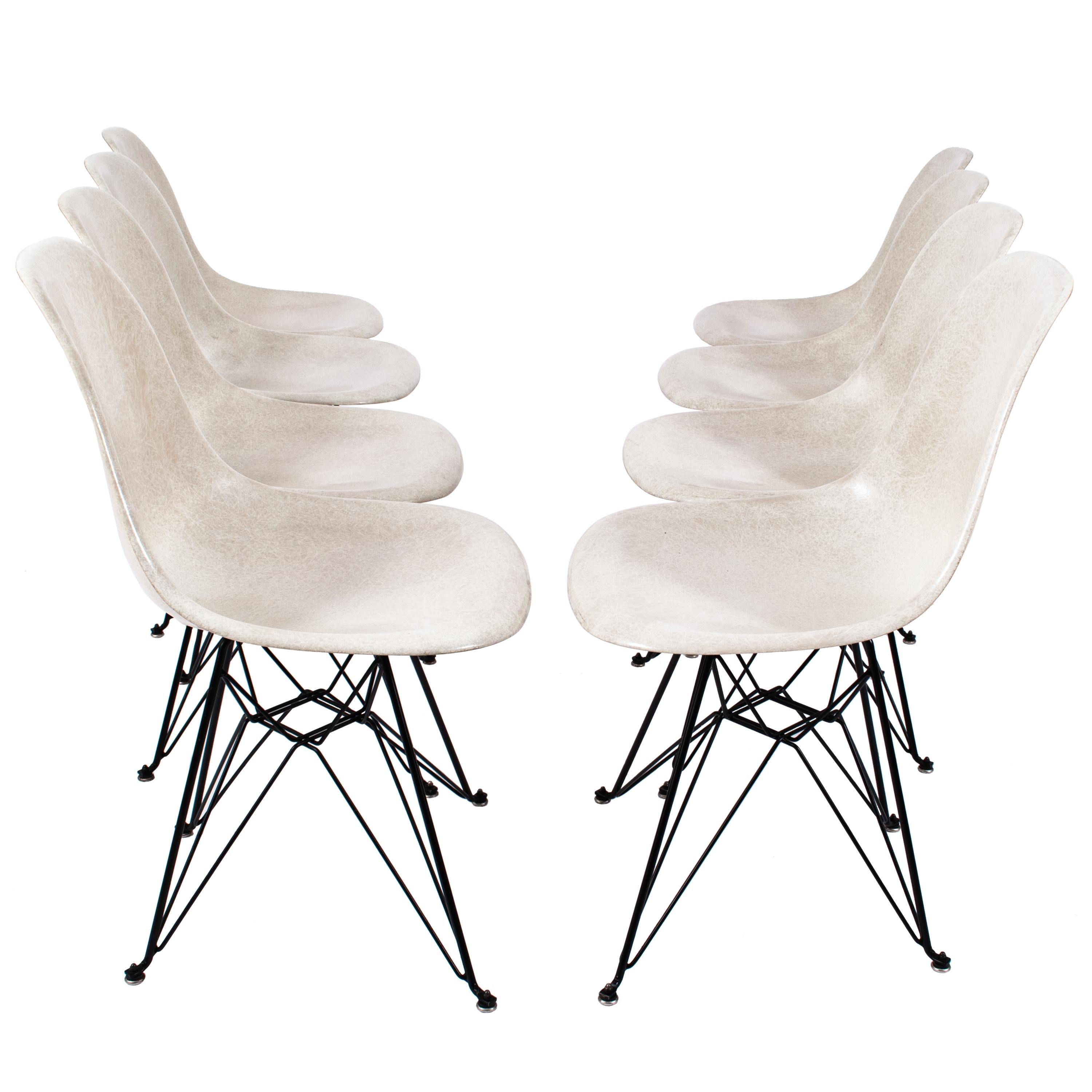 A good set of eight Eames fiberglass shell chairs with 