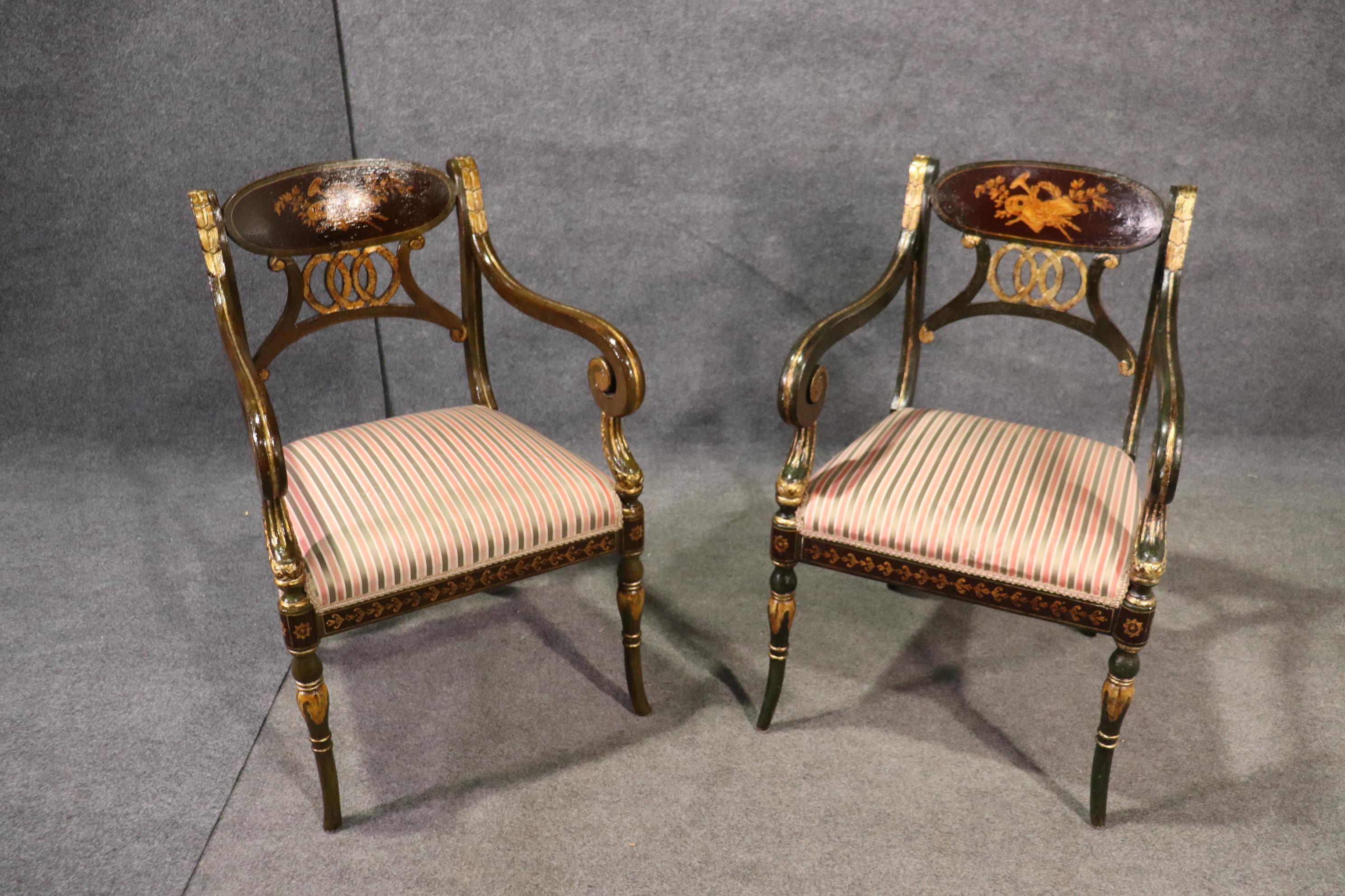 This is a gorgeou set of hand painted and genuine gold leaf gilded Regency dining chairs. They each feature nice upholstered seats and beautiful gold details and muscial instruments as a central motif. They measure 37 tall x 24 wide x 22 deep and
