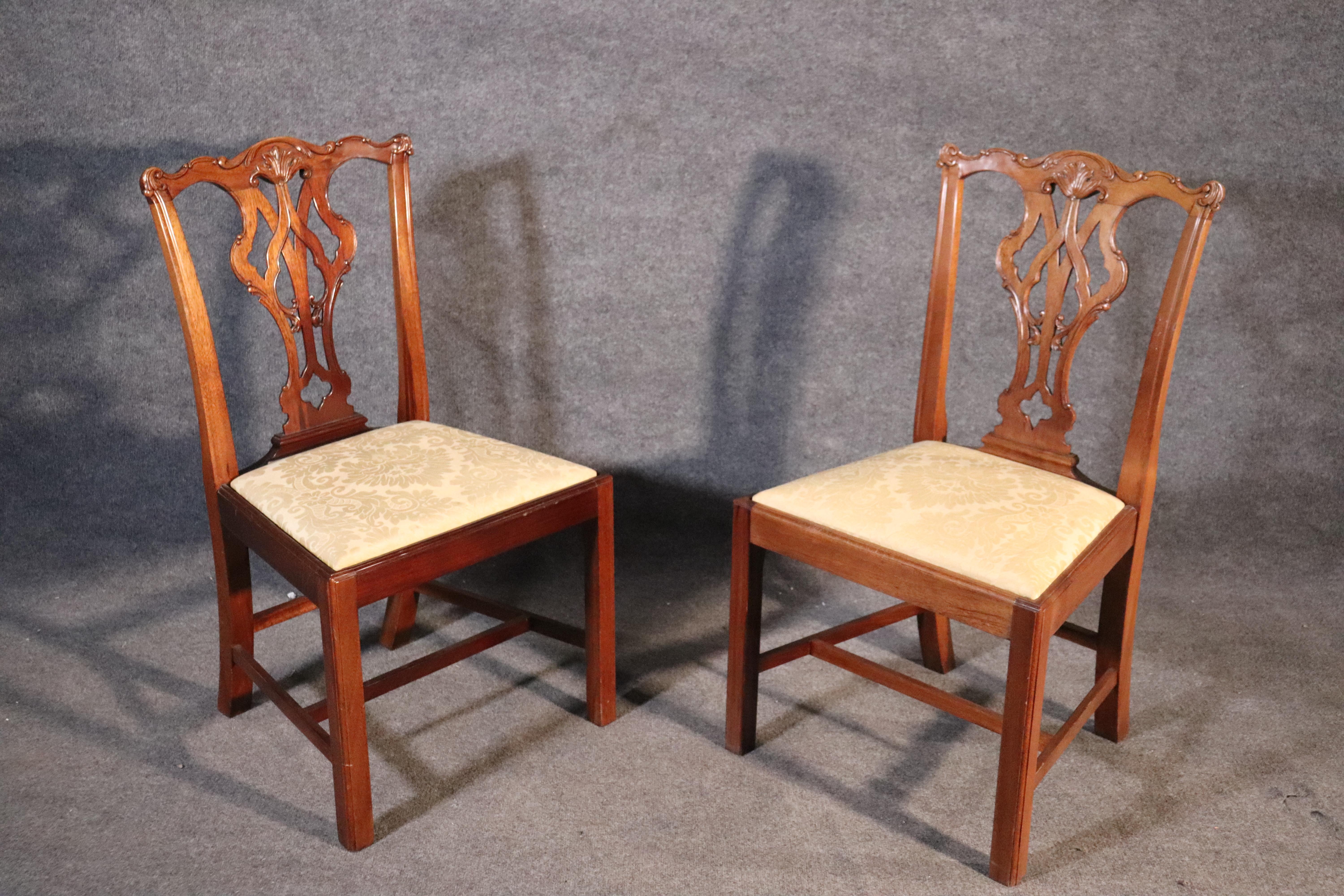 This is a gorgeous set of 1980s era custom made hand carved dining chairs. The chairs are heavy for their size and in good condition. The chairs do exhibit some tonal variations in wood within each of some of the chairs. This is often due to windows