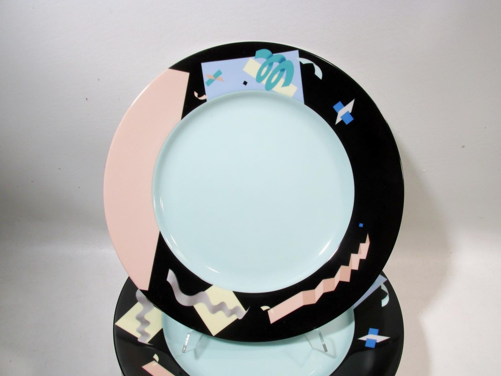 Set of 8 - 12” diameter service plates or chargers. From a renowned 1980s series of architect and prominent designer commissioned tableware designs in fine porcelain from Swid Powell. Designed by Steven Holl, the pattern is the Memphis movement