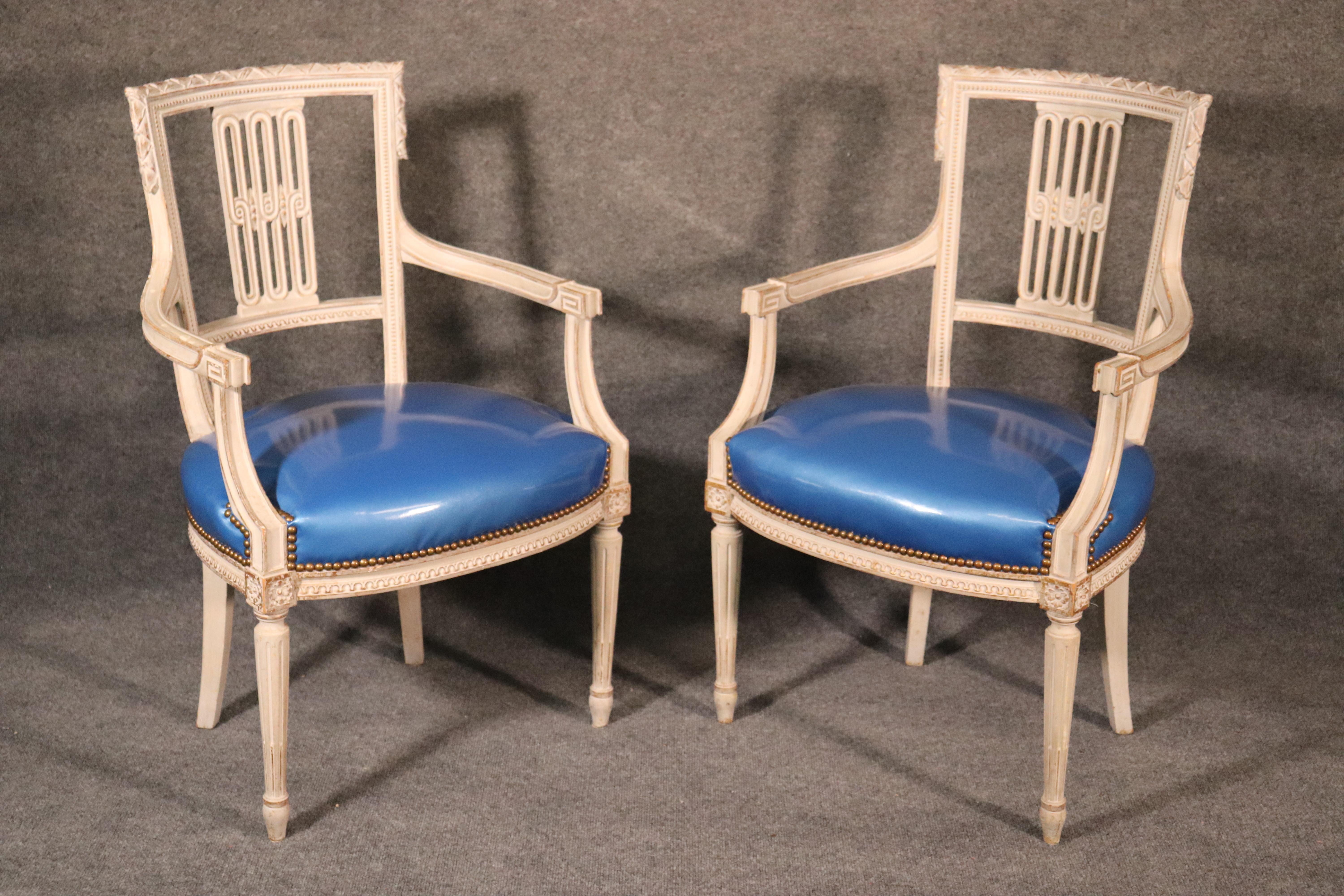 This is a rare set of white painted Louis XVI style Maison Jansen arm chairs-these are all armchairs with no side chairs, circa 1950. The chairs have hints of actual gold leaf underneat the white which is extremely subtle and sophisticated. The