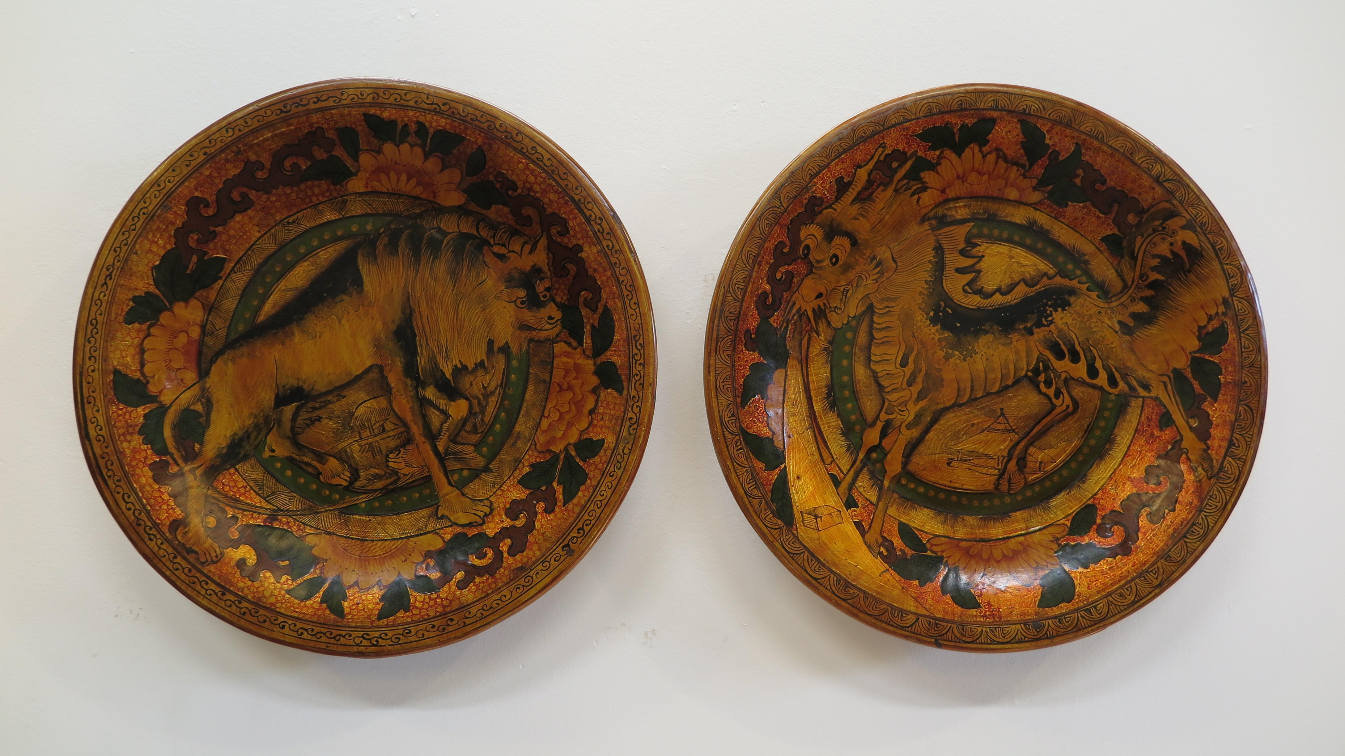 A matched set of Antique Chinese Lacquered Wooden Plates. Sculpted cut Elm wood sections joined together with wooden pins, wire banding and lacquer from the Qing Dynasty. A rare set of Antique Chinese Lacquered Plates. One plate pictures The Wolf