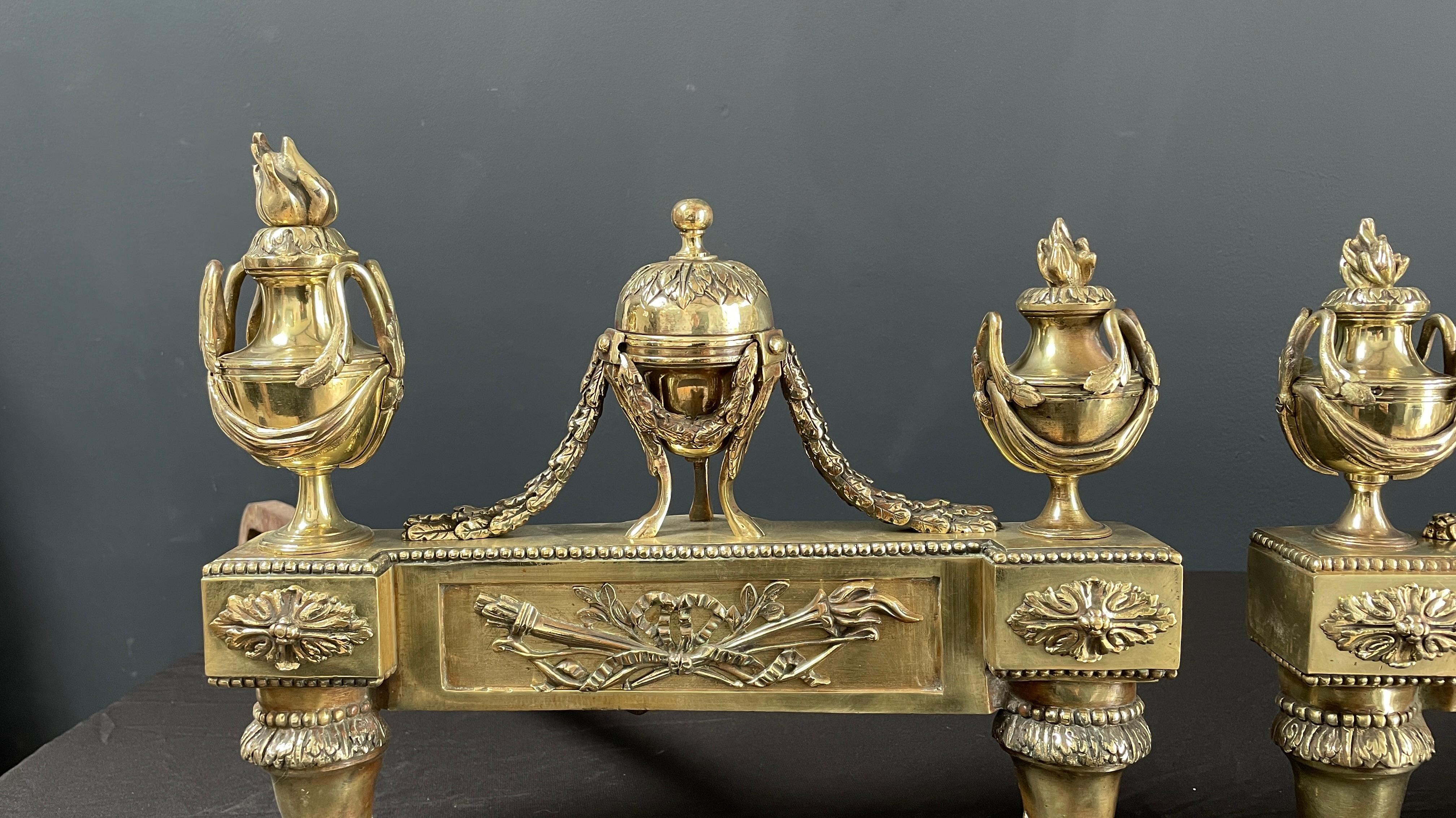 Beautiful set of antique French brass firebombs. This beautiful set has been re-polished. The details on these items are just stunning. 
The length of the legs (posts) are adjustable. We will tailor the size of the legs to your needs.