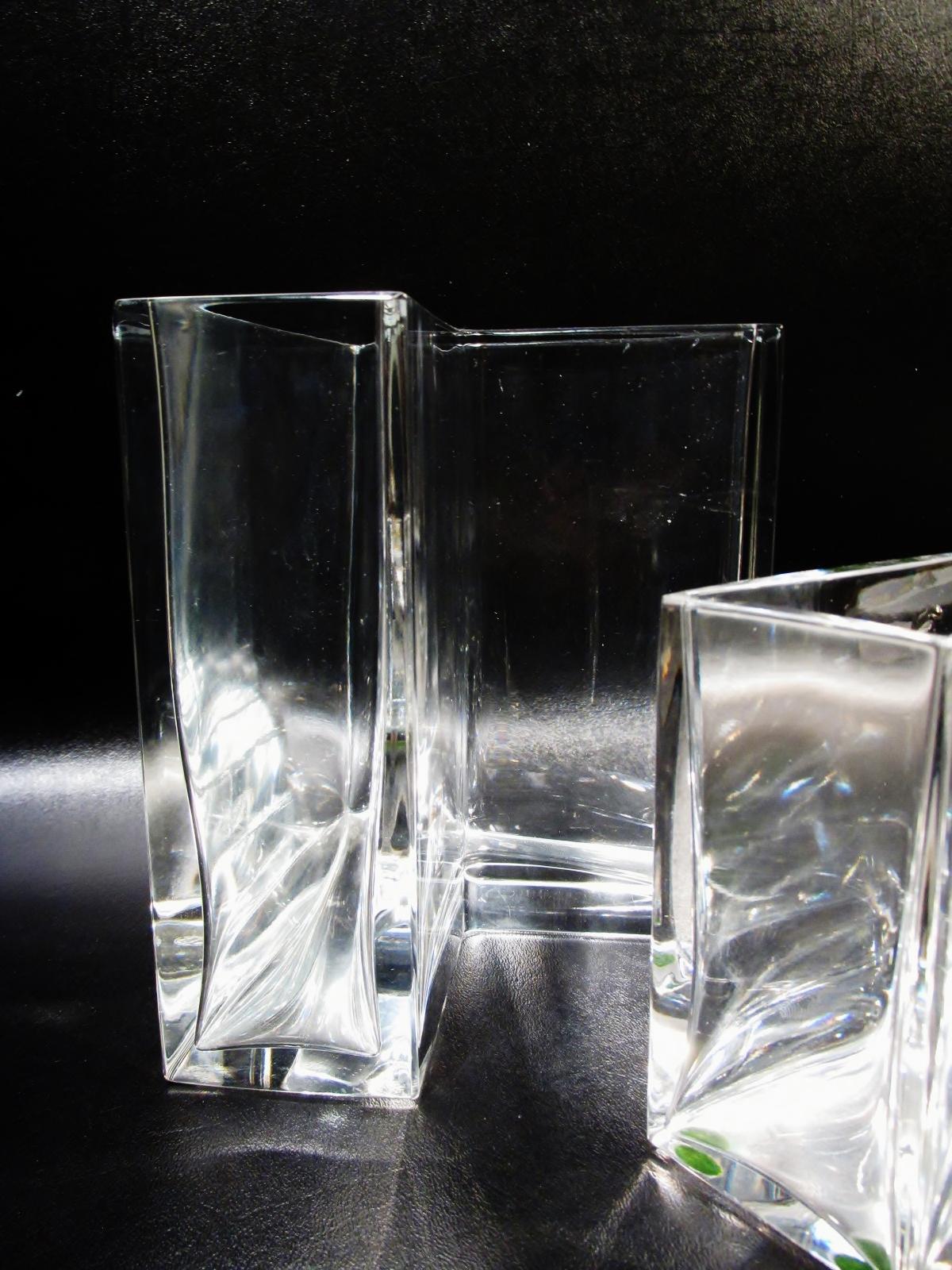 Rarely seen pair of Baccarat fine crystal Angolari vases. Also called the angular vases, these were designed in 1978, came in several heights, by Roberto Sambonet. Heavy in the hand and made in France. Both are 5 7/8” along sides, shorter is 7.75”