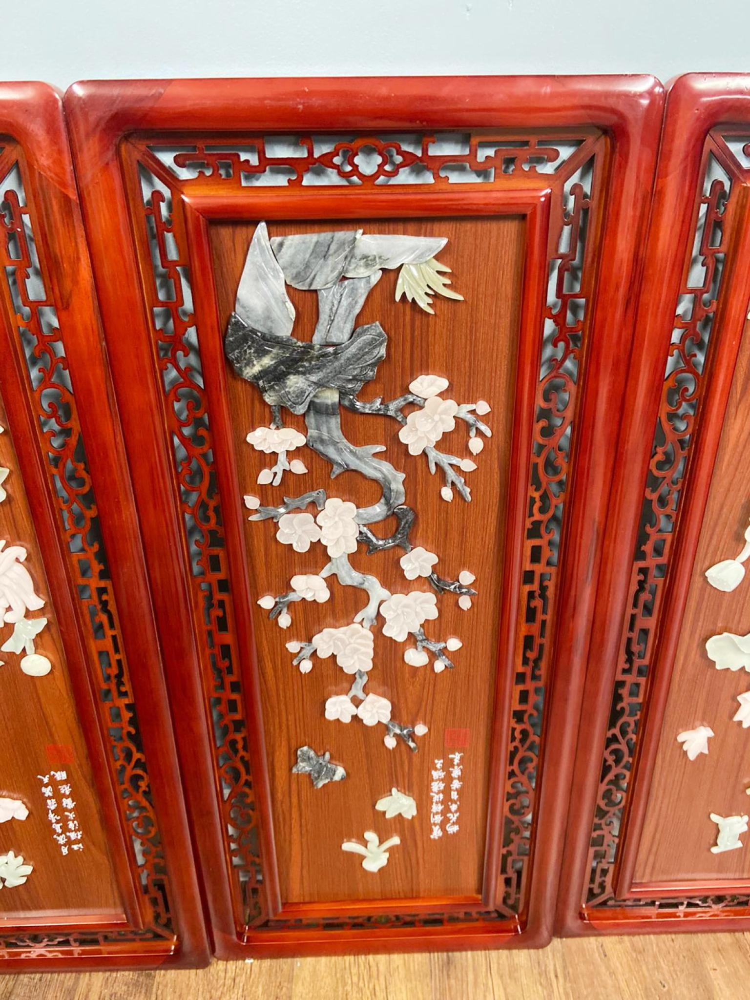 A striking set of four Chinese wall panels, each finely carved in low relief with hardstone appliqué depicting traditional motifs
The scenes include floral sprays, birds, gourds, and chrysanthemums, all executed in delicately coloured stones such as