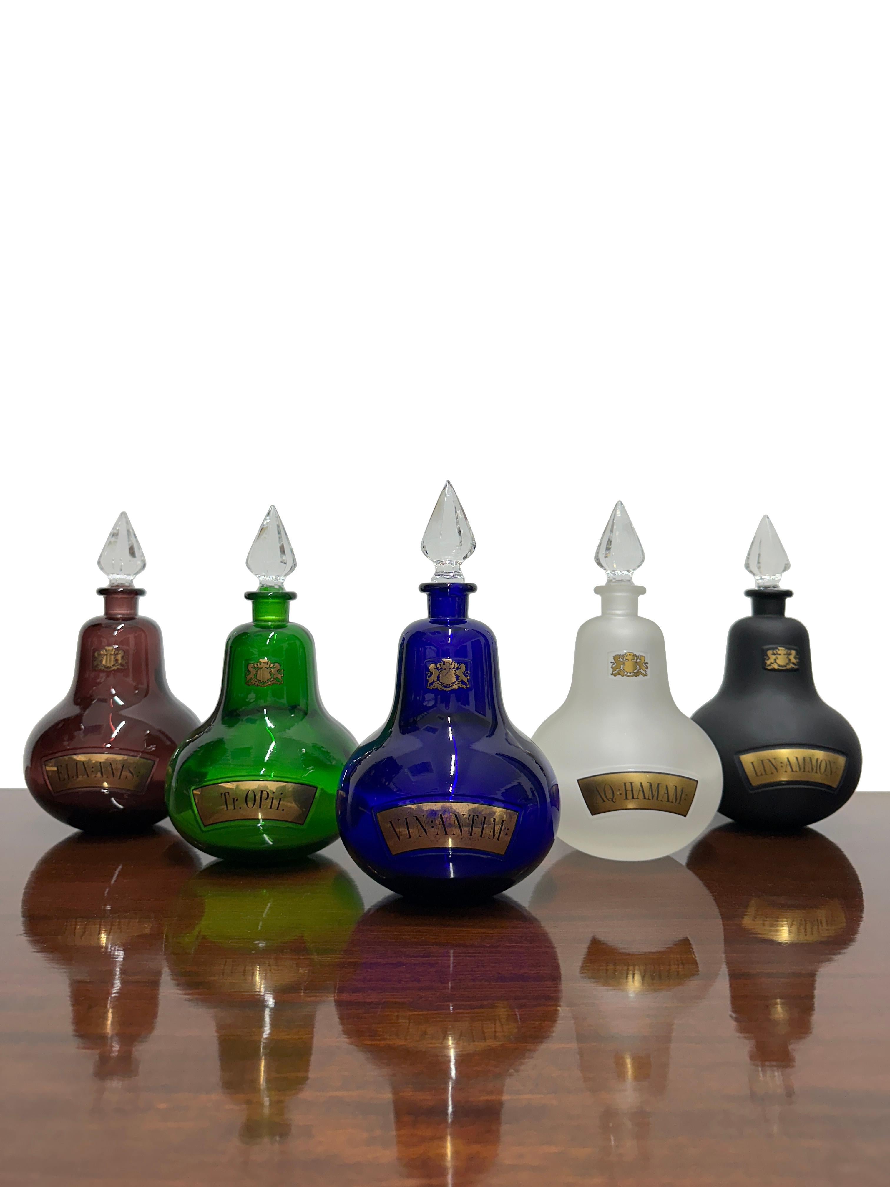 - A rare set of Royal Pharmaceutical Society Collectors Apothecary Bottles, circa 1960.
- There are five bottles in total each of a different colour, each bottle is labeled in Latin with exquisite gold leaf, the Royal Pharmaceutical Society crest