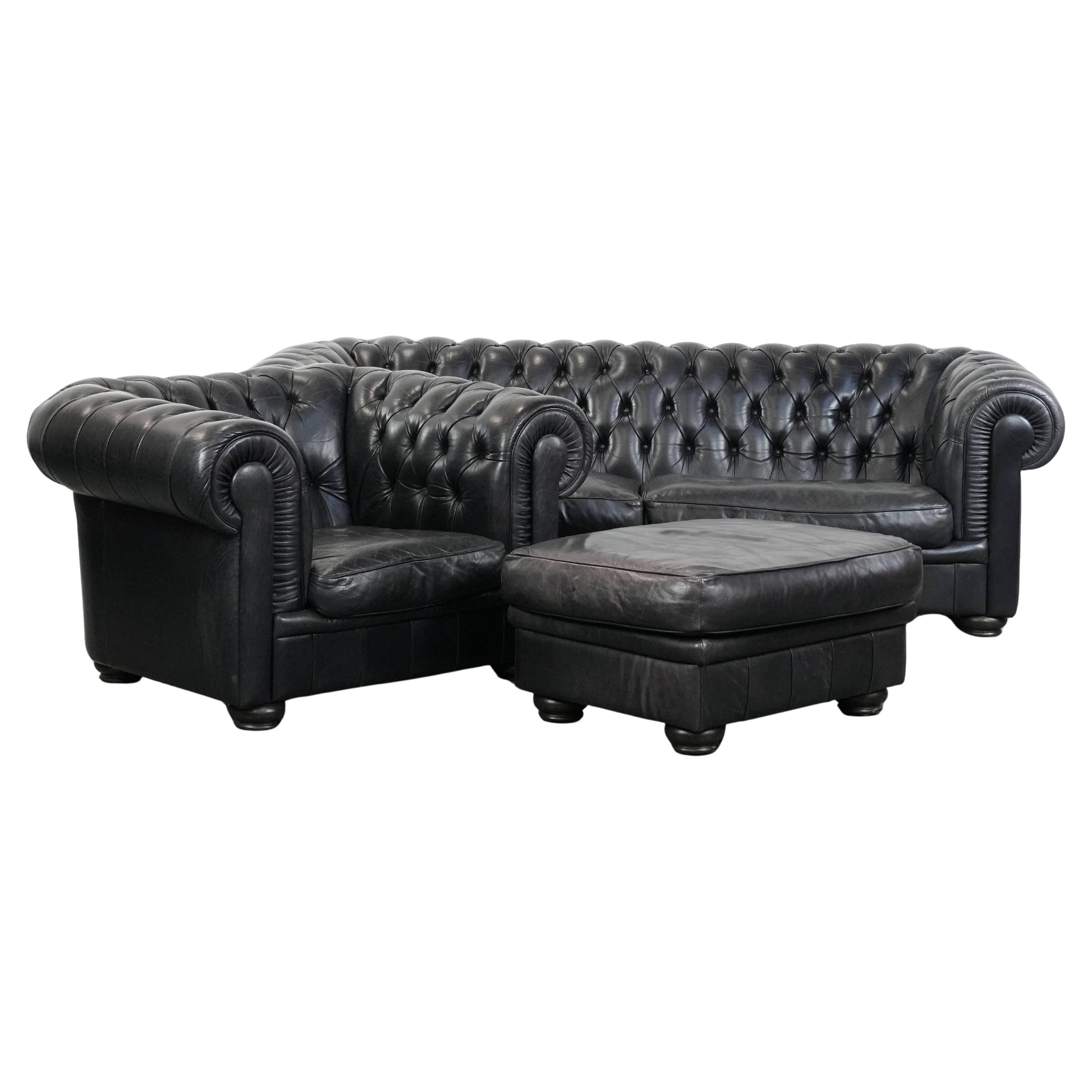 Set consisting of a black chesterfield sofa, armchair and ottoman