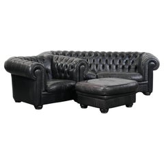 Set consisting of a black chesterfield sofa, armchair and ottoman