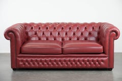 Set consisting of a English cowhide Chesterfieldsofa and matching armchair