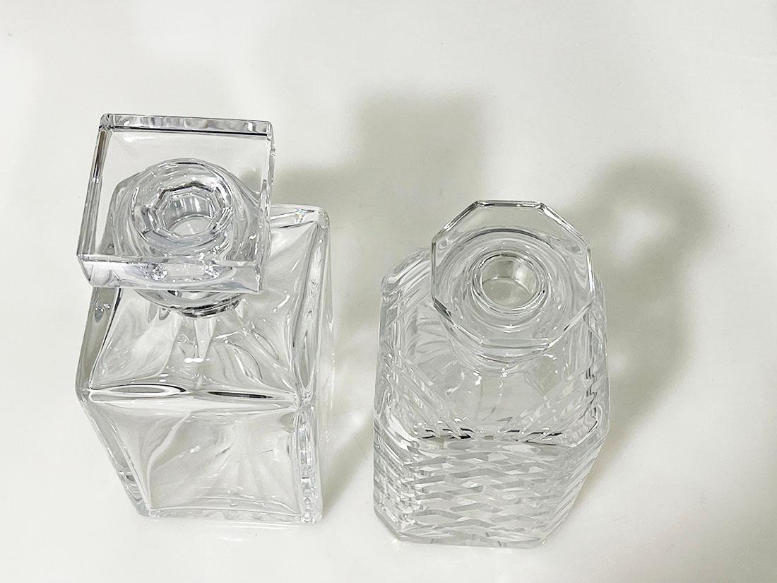 Set crystal cut whiskey decanters, one by Atlantis

A set crystal cut whiskey decanters. A crystal cut with diamond cut pattern with stopper in octagonal shape (stopper has a small dent). A smooth crystal decanter with stopper in heavy quality