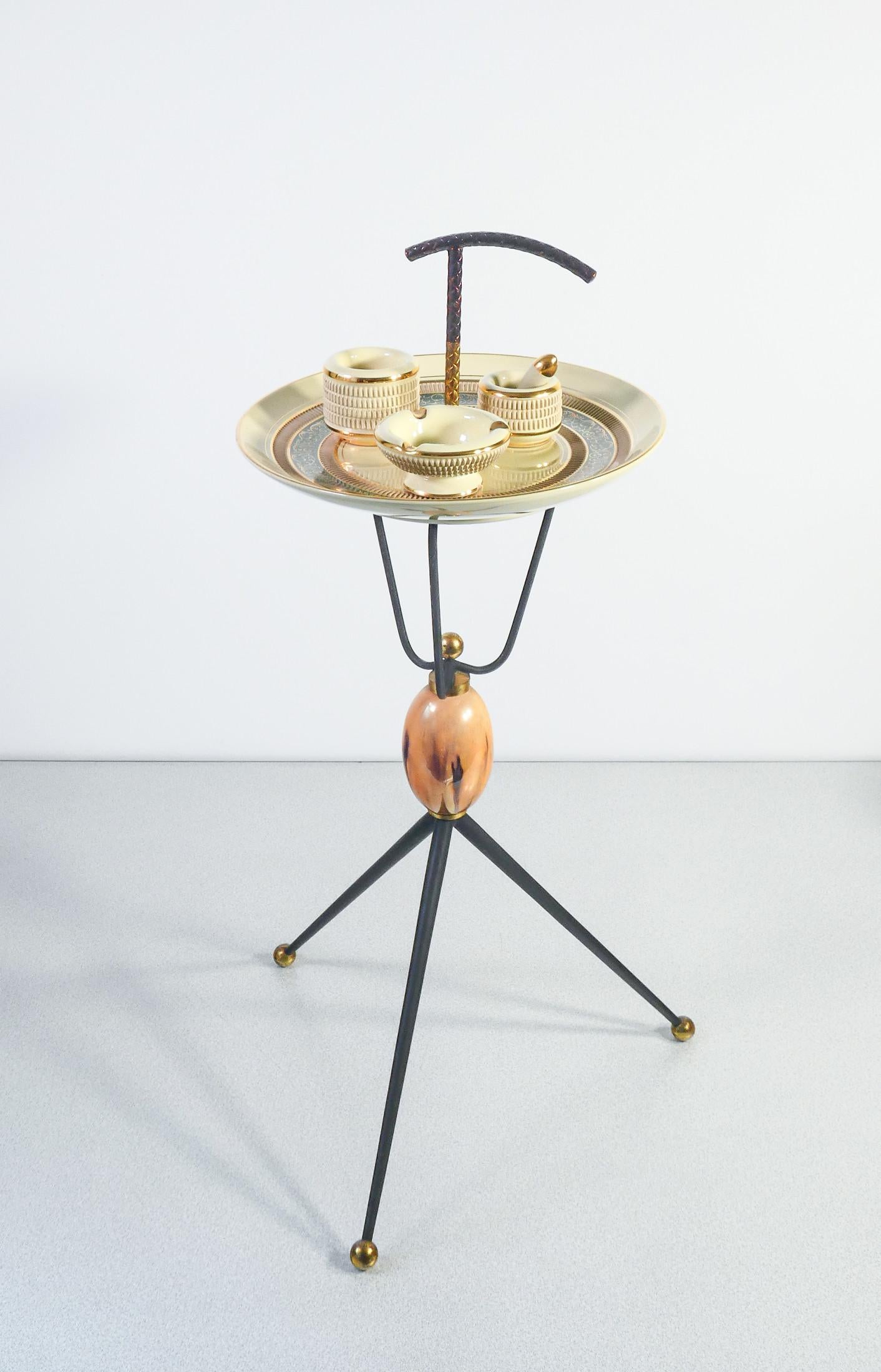 Ceramic smoking set
and metal composed of
an ashtray,
a small mortar and
a container, arranged
on tripod table.
Italy, 1950s/60s

ORIGIN
Italy

PERIOD
1950s/60s

MATERIALS
Ceramics and metal

DIMENSIONS
H 69 cm
Plate Ø 29 cm

CONDITIONS
The piece is