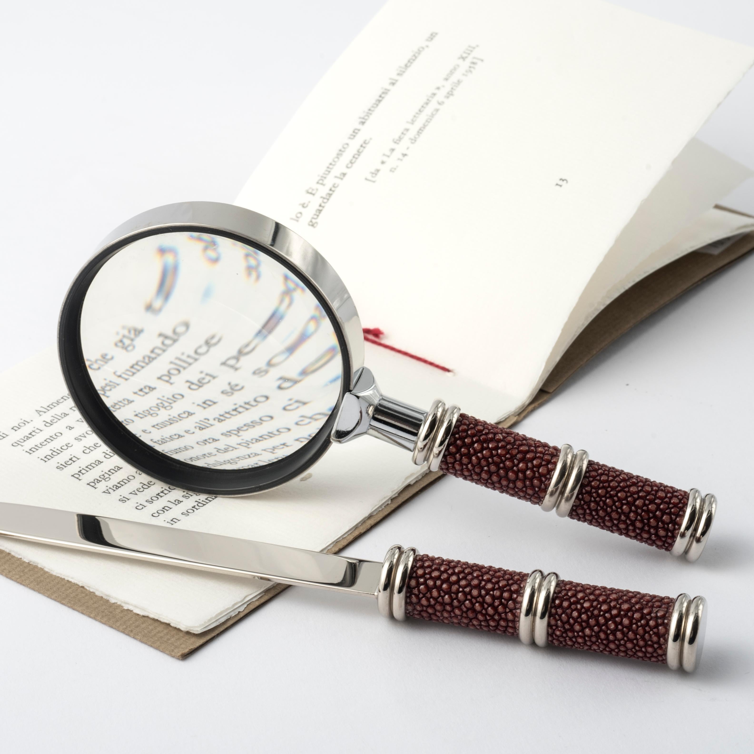 Discover the timeless elegance of the burgundy red shagreen leather desk set, a refined combination of modern design and Art Deco details. 
This unique set, consisting of a magnifying glass and letter opener, is perfect for those who appreciate