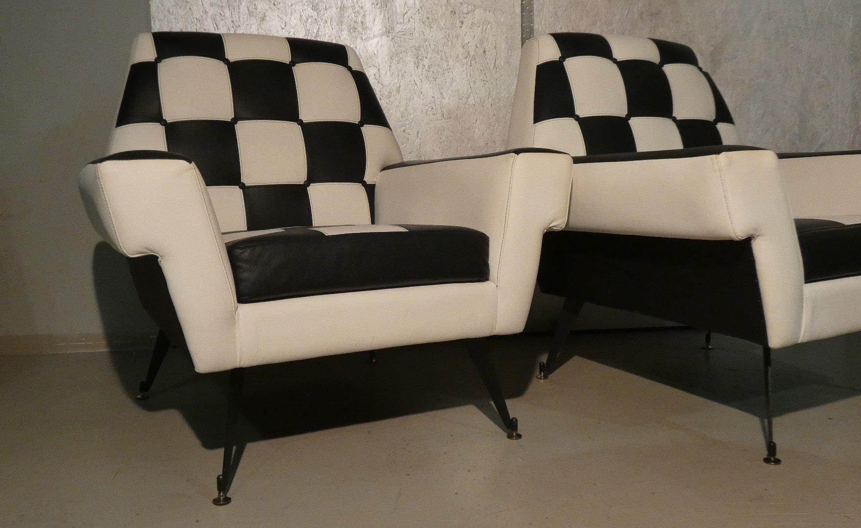 Pair of 1960s armchairs with foam padding and two-tone vinyl leather upholstery.

The width of the seat makes them extremely comfortable, and even the backrest, while slightly stiff has an ergonomics that gives pleasant comfort.

The accuracy in