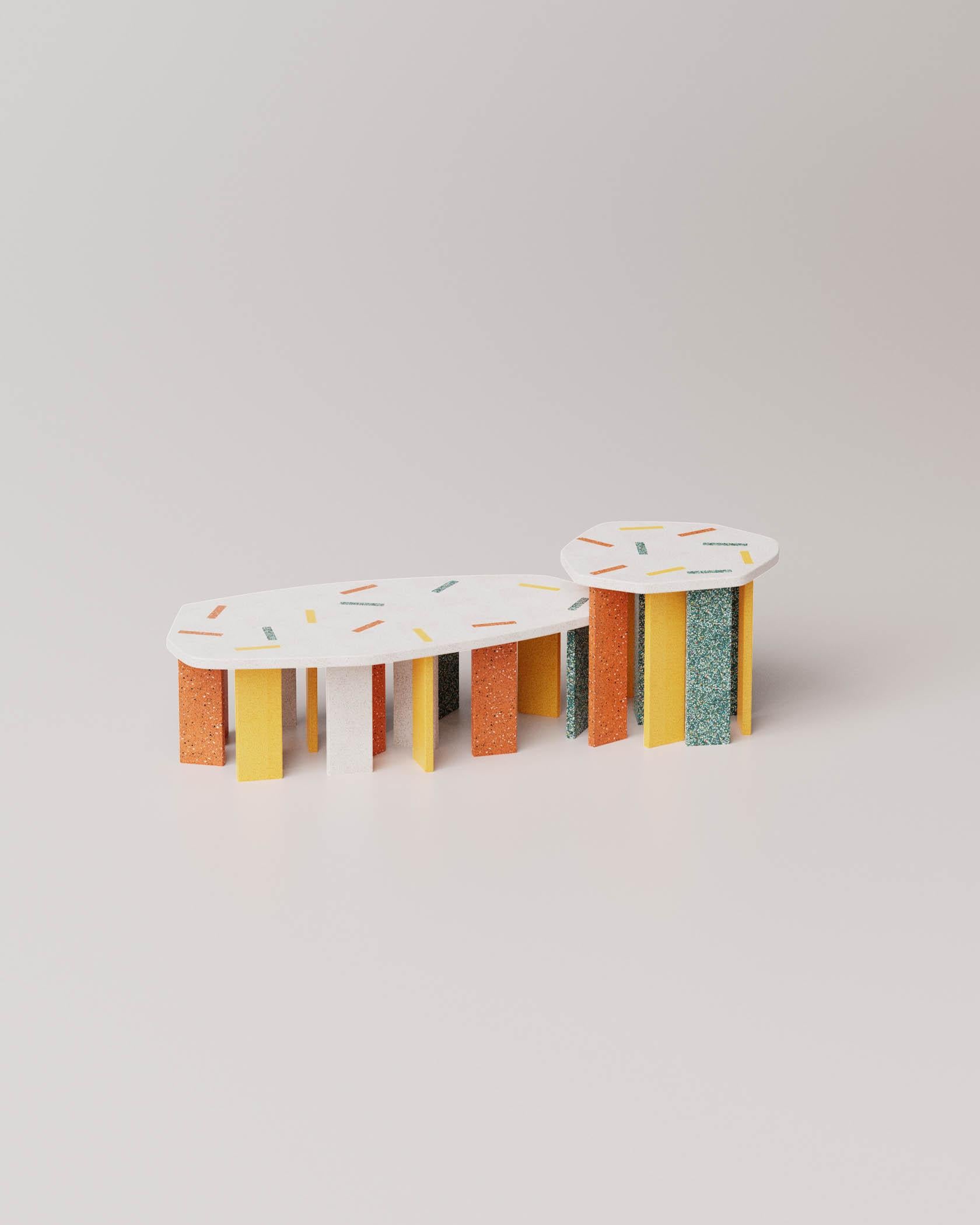 This pair of tables originates from an approach that considers offcuts as a genuine design resource. The small fragments derived from the processing of a 100% recyclable material containing recycled plastic are reinterpreted by Enrico Girotti as