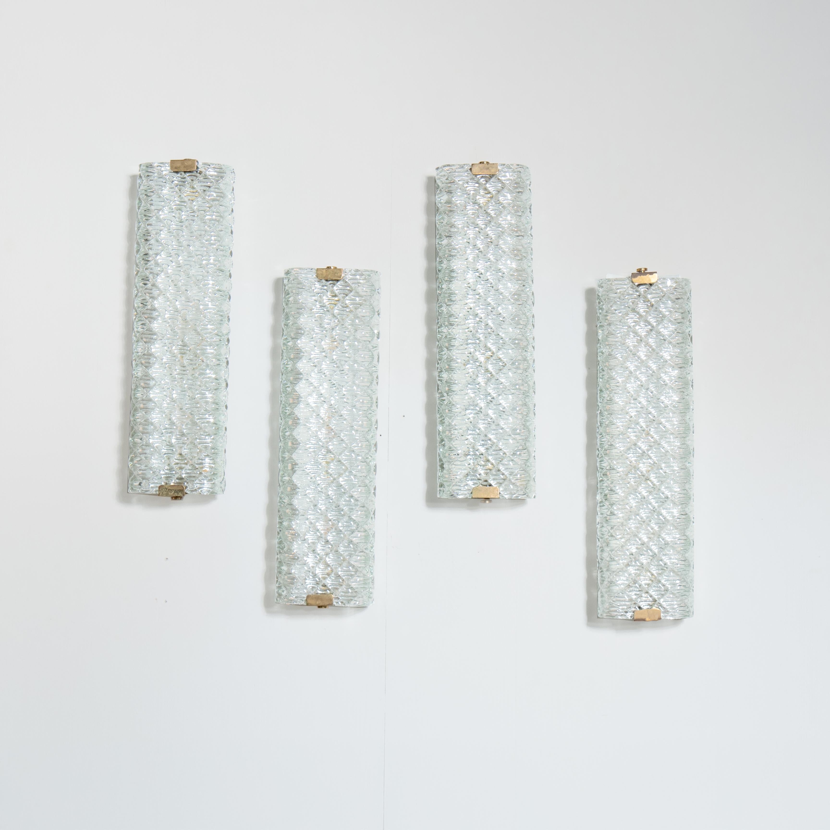 Set of 4 Murano glass wall sconces, Venini, Italy. The design and geometric workings of glass, diffusing light harmoniously and softly. An example of Italian design excellence in lighting, these wall sconces represent a perfect balance of