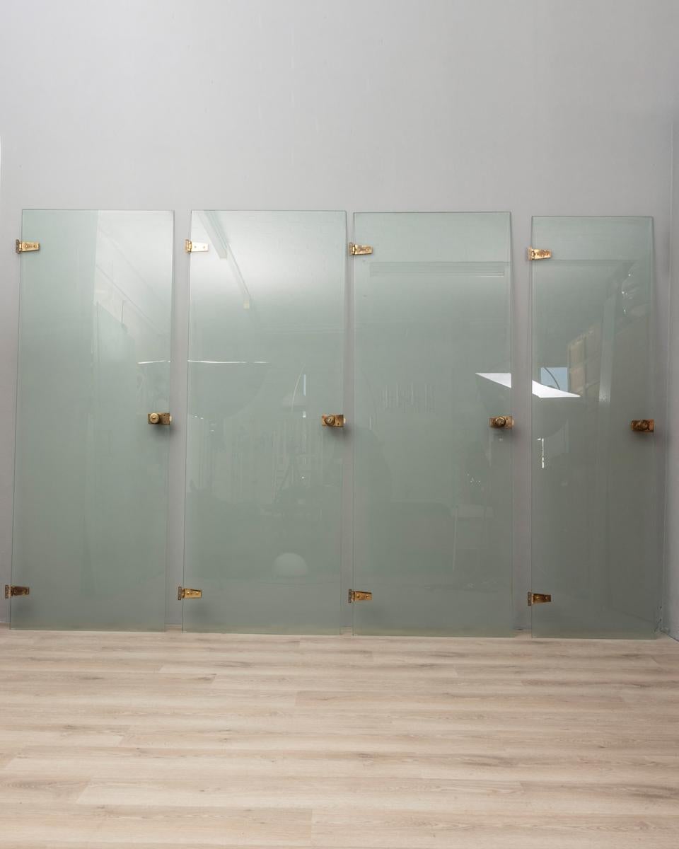 Set of four tempered glass doors with gold-plated brass inserts and handles, fitted with a key. Design Fontana Arte, 1960s.

CONDITION:
In good, working condition, may show signs of wear given by time.

SIZING:
1) Height 219 cm; width 80 cm; length