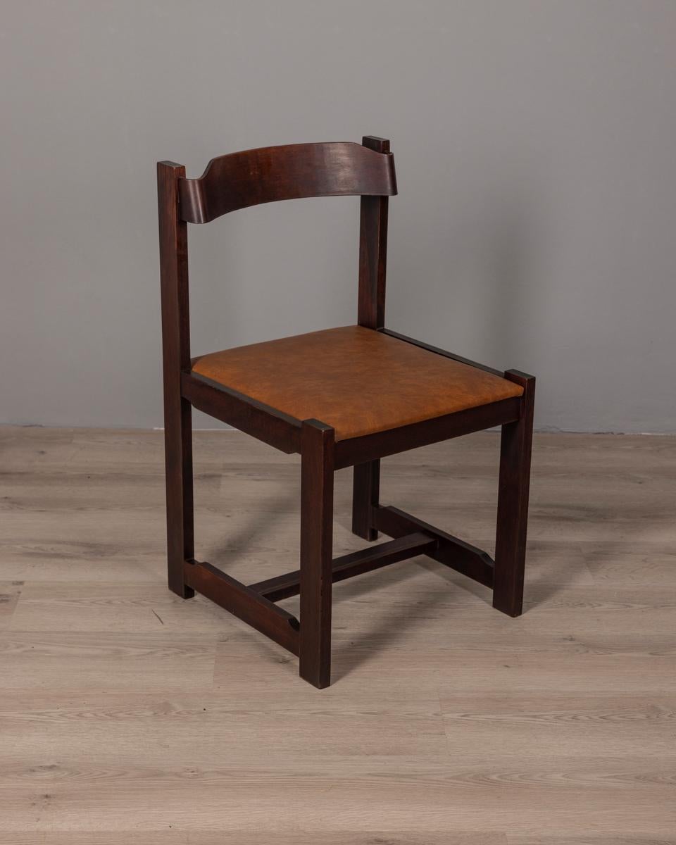 Set of four chairs with wooden frame and brown vinyl leather upholstery, Italian design, 1960s.

CONDITION:
In good condition, may show signs of wear and tear given by time

SIZING:
Height 77 cm; Width 45 cm; Length 45 cm