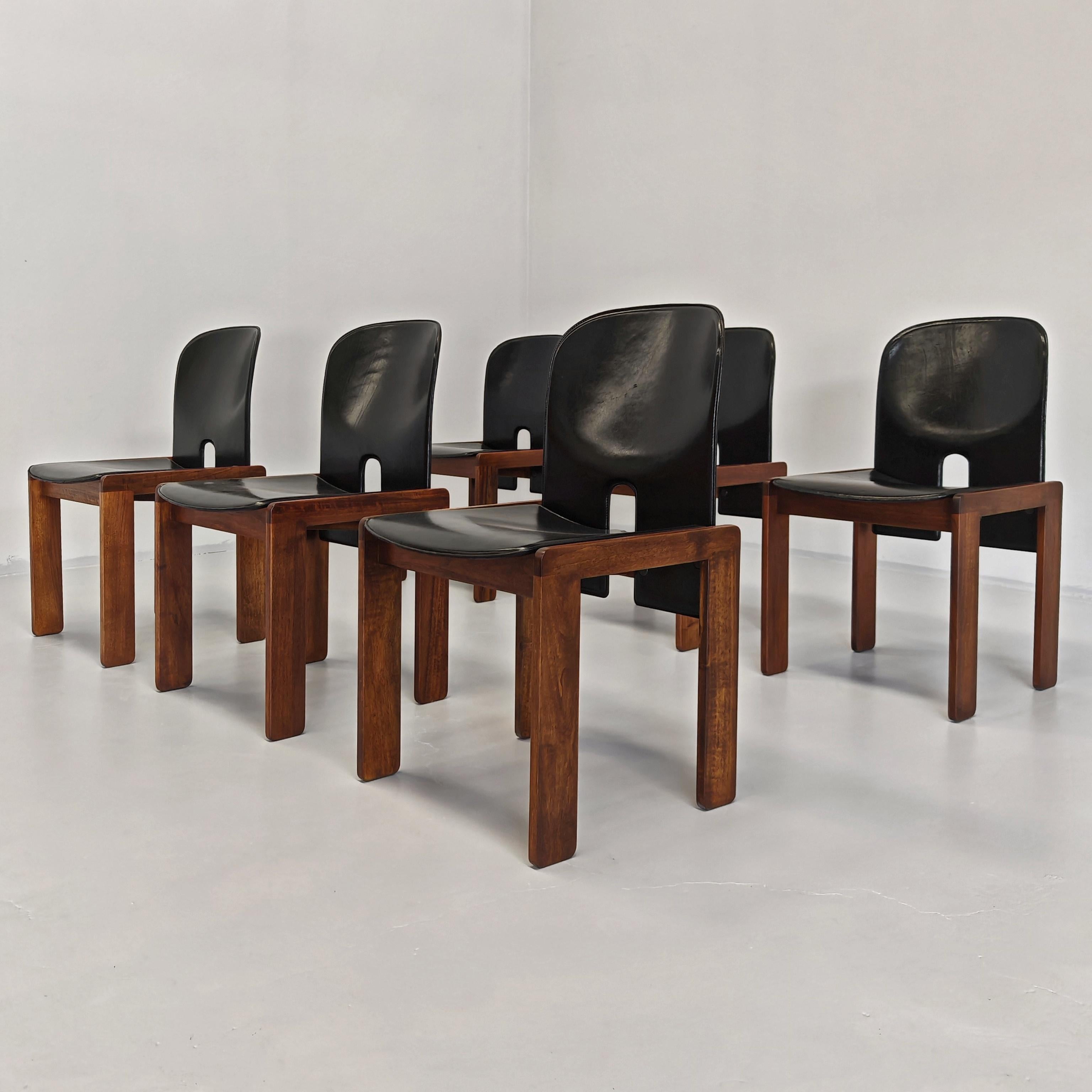 Elegant and iconic set of 6 model 121 chairs designed in the late 1960s by famous designers Afra and Tobia Scarpa for Cassina. The Chairs consist of a walnut wood base while the seat and back are made of curved black leather.

