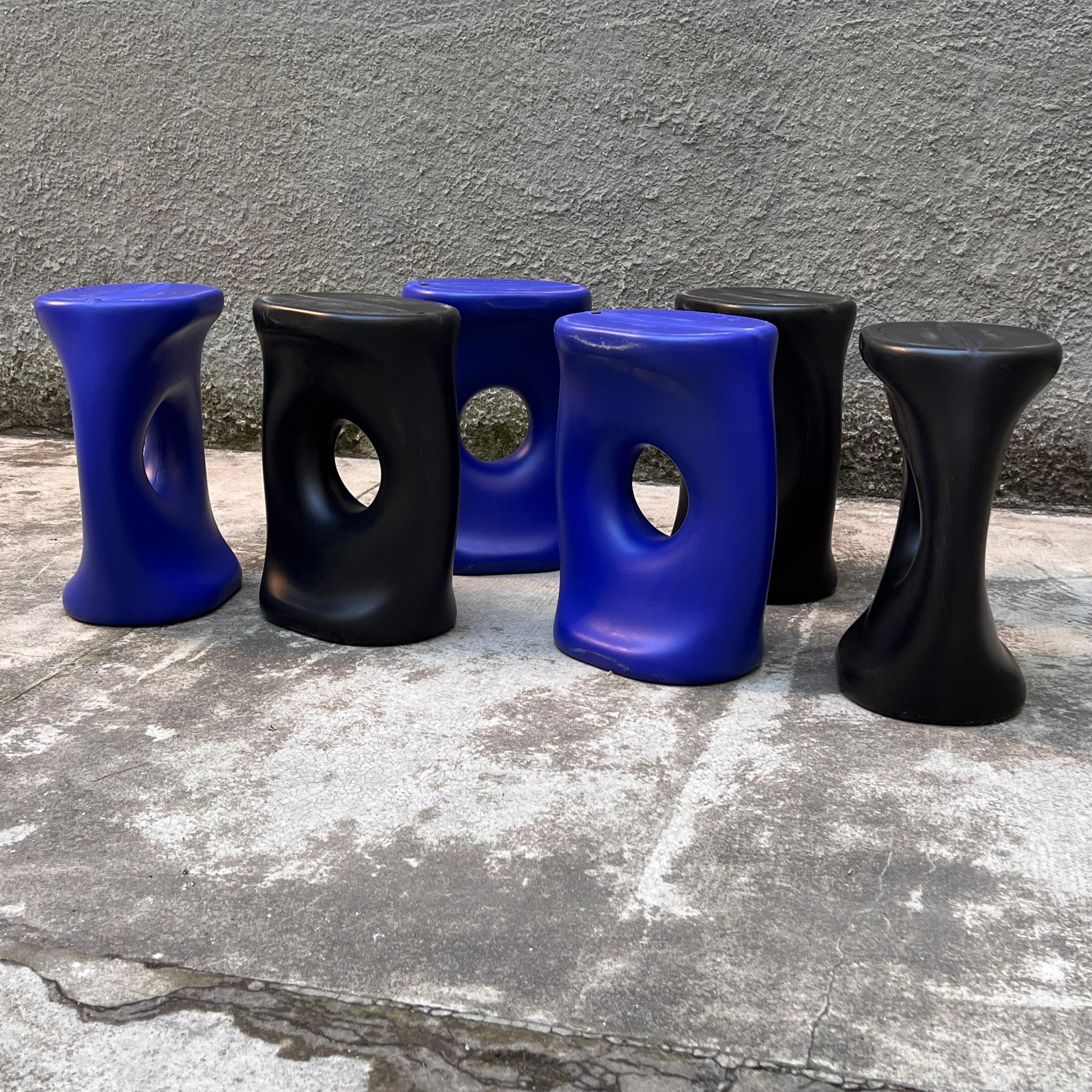 Fun and practical plastic stools designed by Yuko Tsurumaru for Hidden. 
Stackable, they simultaneously solve two problems: space to stow them and the number of seats in case of need.
Three black and three blue, then they become fun and colorful