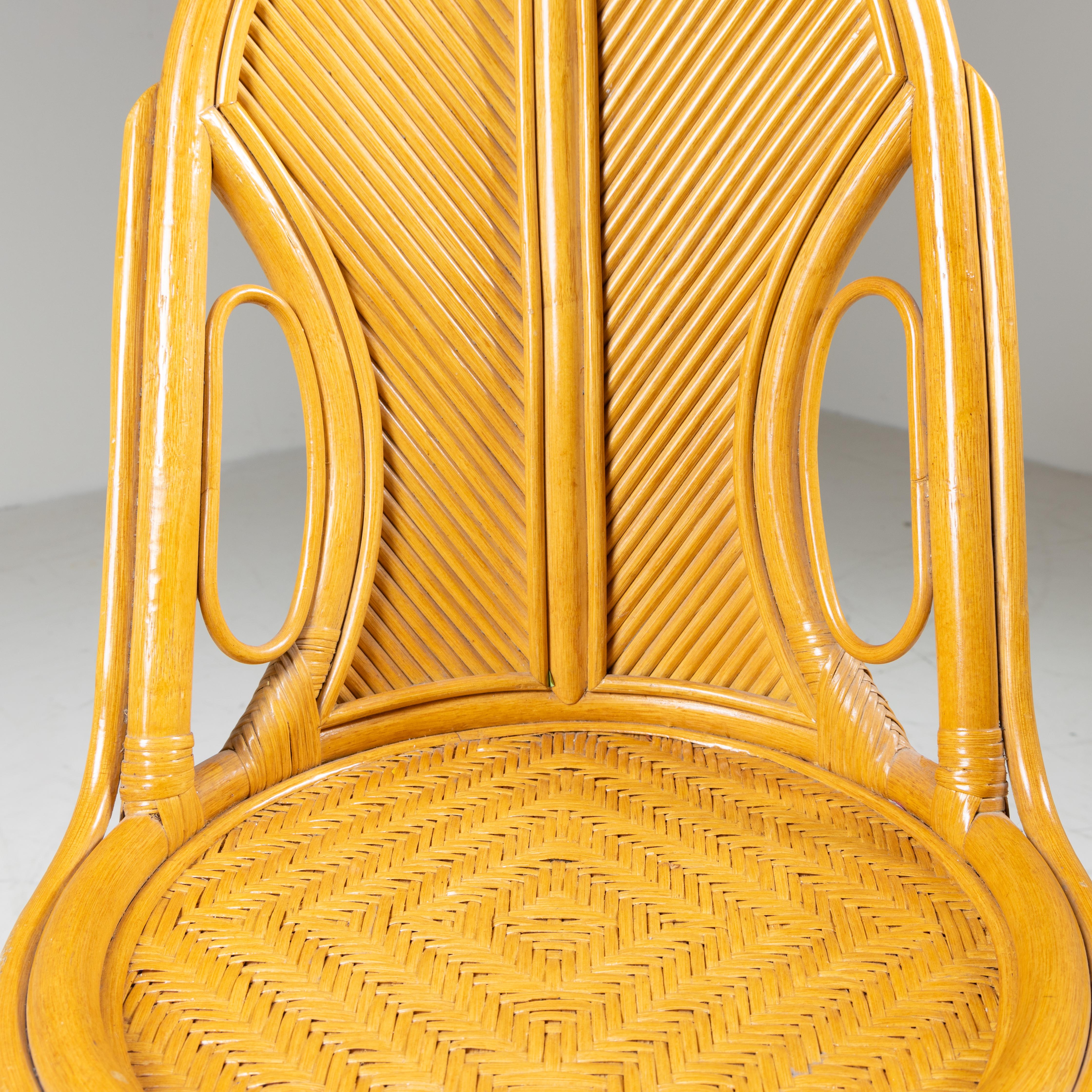 Rattan console table, mirror and stool set, Italian manufacture, 1970. Elegant composition made entirely of rattan, characterized by sinuous lines and refined weaves typical of 1970s design. The console table features a slim top with a woven