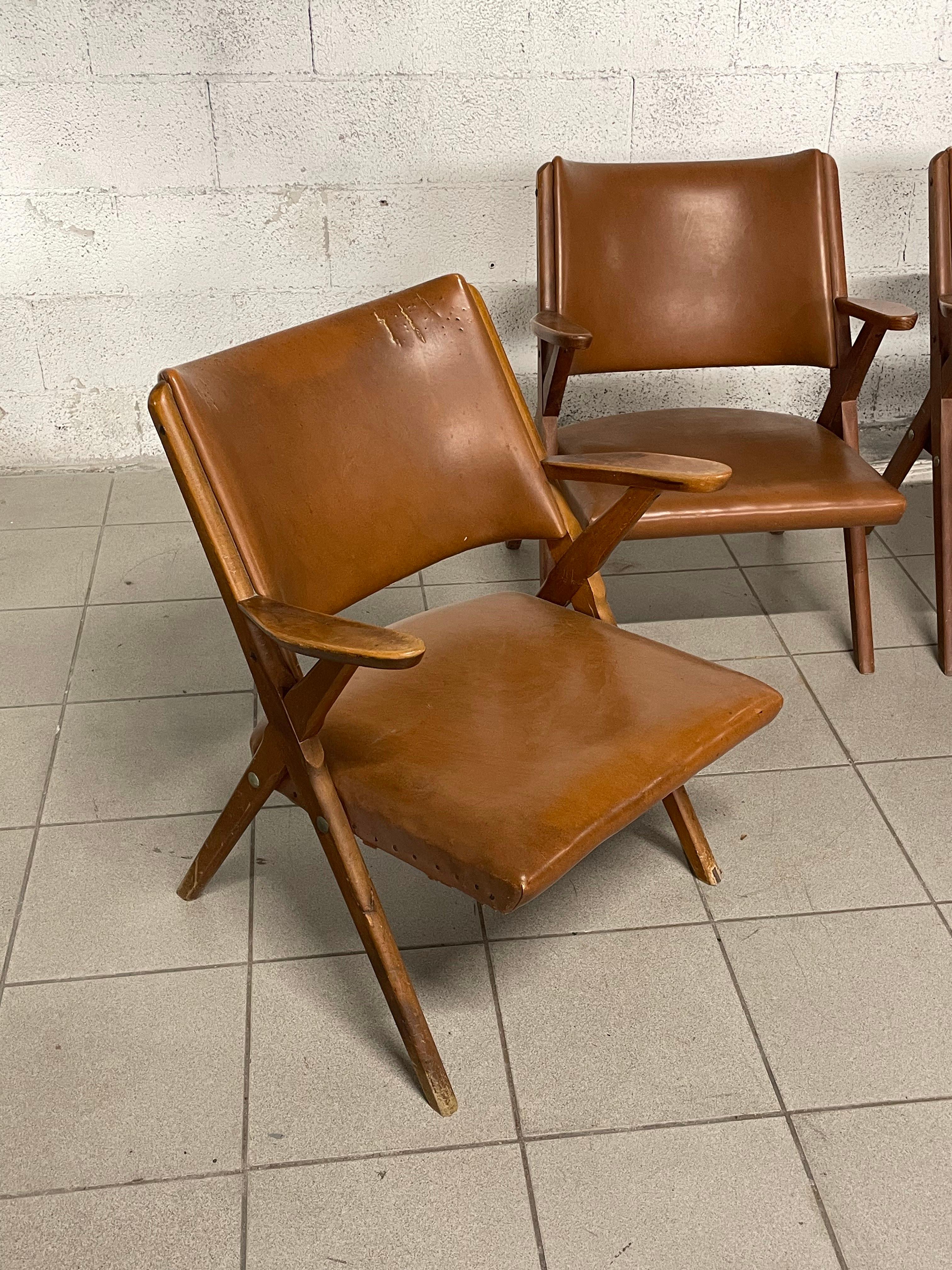 Set of 4 Scandinavian-designed 1960s armchairs produced by the historic DAL VERA furniture factory in Conegliano Veneto, Italy, and designed by Antonio Dal Vera himself.

They are made of solid wood and with brown faux leather upholstery. La